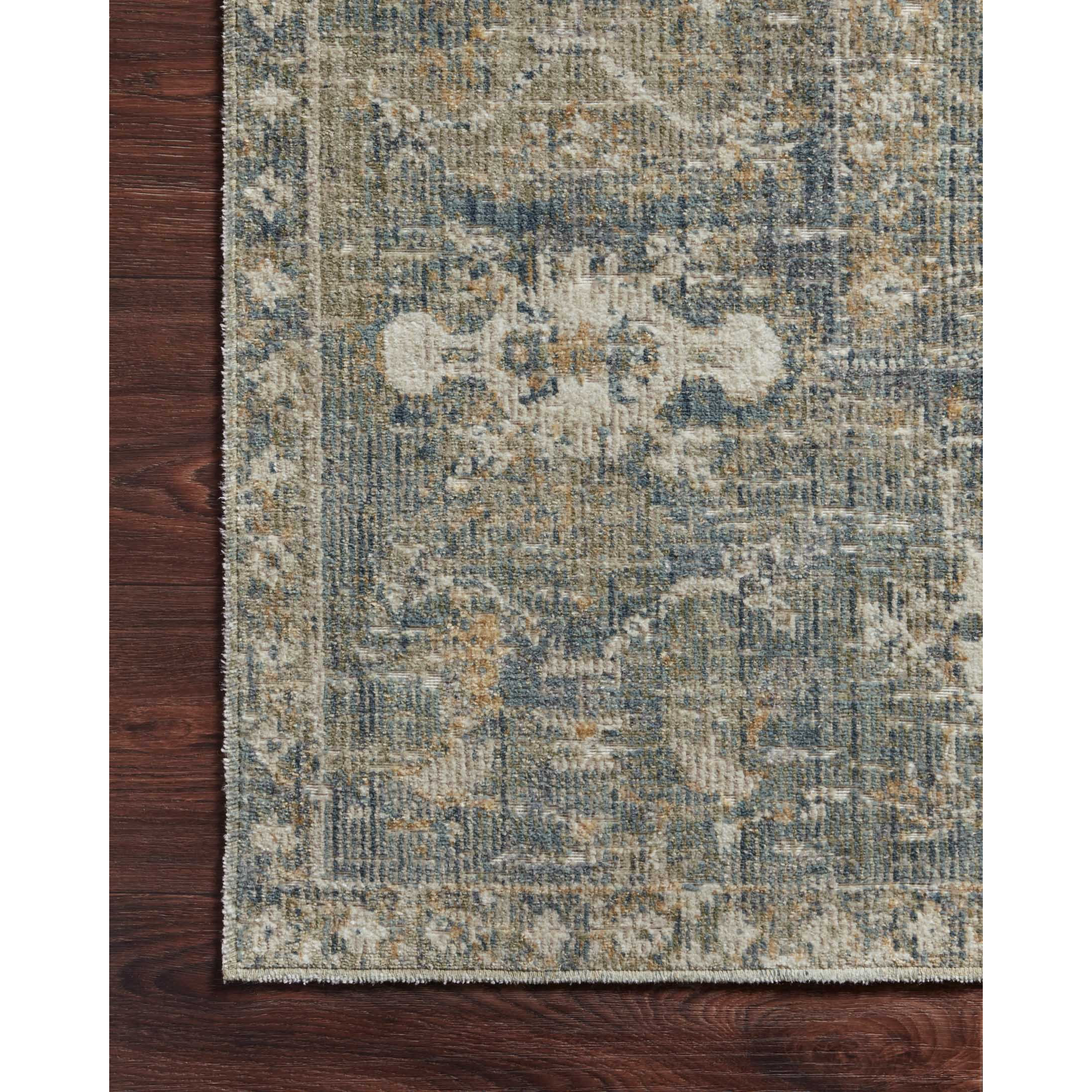Durable, low pile, and soft, this rug is inspired by classic vintage and antique rugs. The Rosemarie Chris Loves Julia Sand / Lagoon ROE-03 rug from Loloi features a beautiful vintage pattern and patina. The rug is easy to clean, never sheds, and perfect for living rooms, dining rooms, hallways, and kitchens!