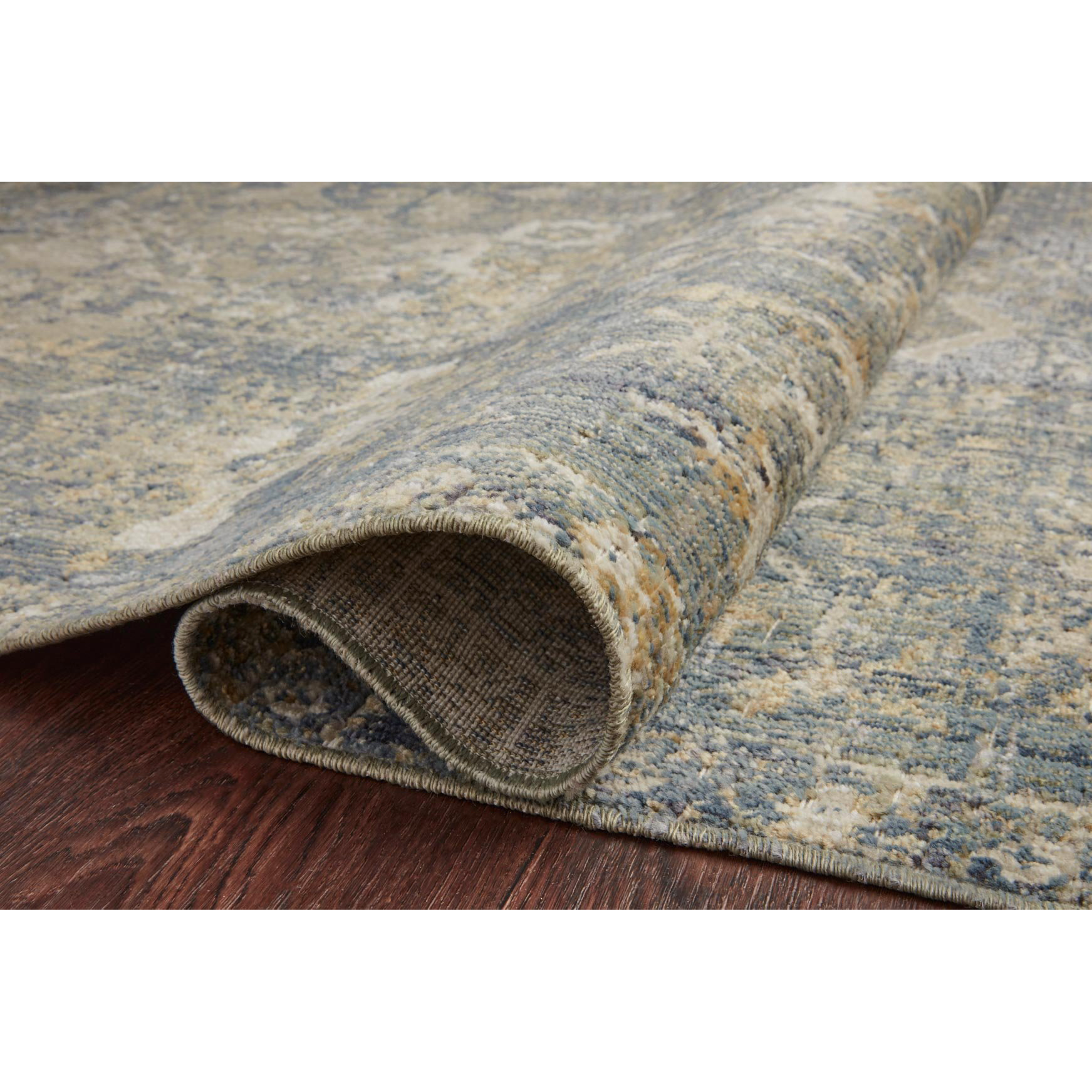 Durable, low pile, and soft, this rug is inspired by classic vintage and antique rugs. The Rosemarie Chris Loves Julia Sand / Lagoon ROE-03 rug from Loloi features a beautiful vintage pattern and patina. The rug is easy to clean, never sheds, and perfect for living rooms, dining rooms, hallways, and kitchens!