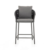 Featuring Porto Venao Charcoal Outdoor Bar & Counter Stool by Four Hands at Amethyst Home. The perfect place for outdoor daydreaming. A beautiful rope-based design is woven across a durable aluminum frame in a rich bronze finish. Topped with a wide cushion and throw pillows, all upholstered in 100% olefin, known for its UV-resistant, water-repellent and quick-drying abilitiesBar S. Amethyst Home provides interior design, new construction, custom furniture, and area rugs in the Calabasas metro area