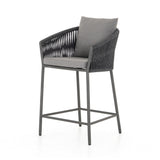 Featuring Porto Venao Charcoal Outdoor Bar & Counter Stool by Four Hands at Amethyst Home. The perfect place for outdoor daydreaming. A beautiful rope-based design is woven across a durable aluminum frame in a rich bronze finish. Topped with a wide cushion and throw pillows, all upholstered in 100% olefin, known for its UV-resistant, water-repellent and quick-drying abilitiesBar Stool. Amethyst Home provides interior design, new construction, custom furniture, and area rugs in the Miami metro area