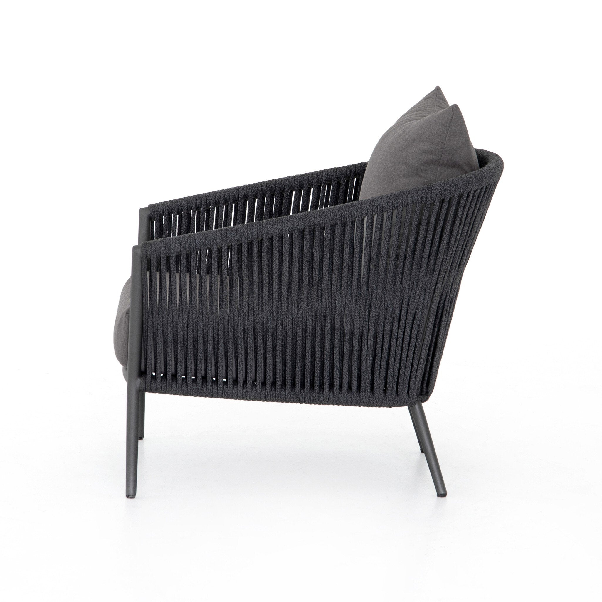 Featuring Porto Venao Charcoal Outdoor Chair by Four Hands at Amethyst Home. The perfect place for outdoor daydreaming. A beautiful rope-based design is woven across a durable aluminum frame in a rich bronze finish. Topped with a wide cushion and throw pillow, all upholstered in 100% olefin, known for its UV-resistant, water-repellent and quick-drying abilities. Cover or store. Amethyst Home provides interior design, new construction, custom furniture, and area rugs in the Newport Beach metro area