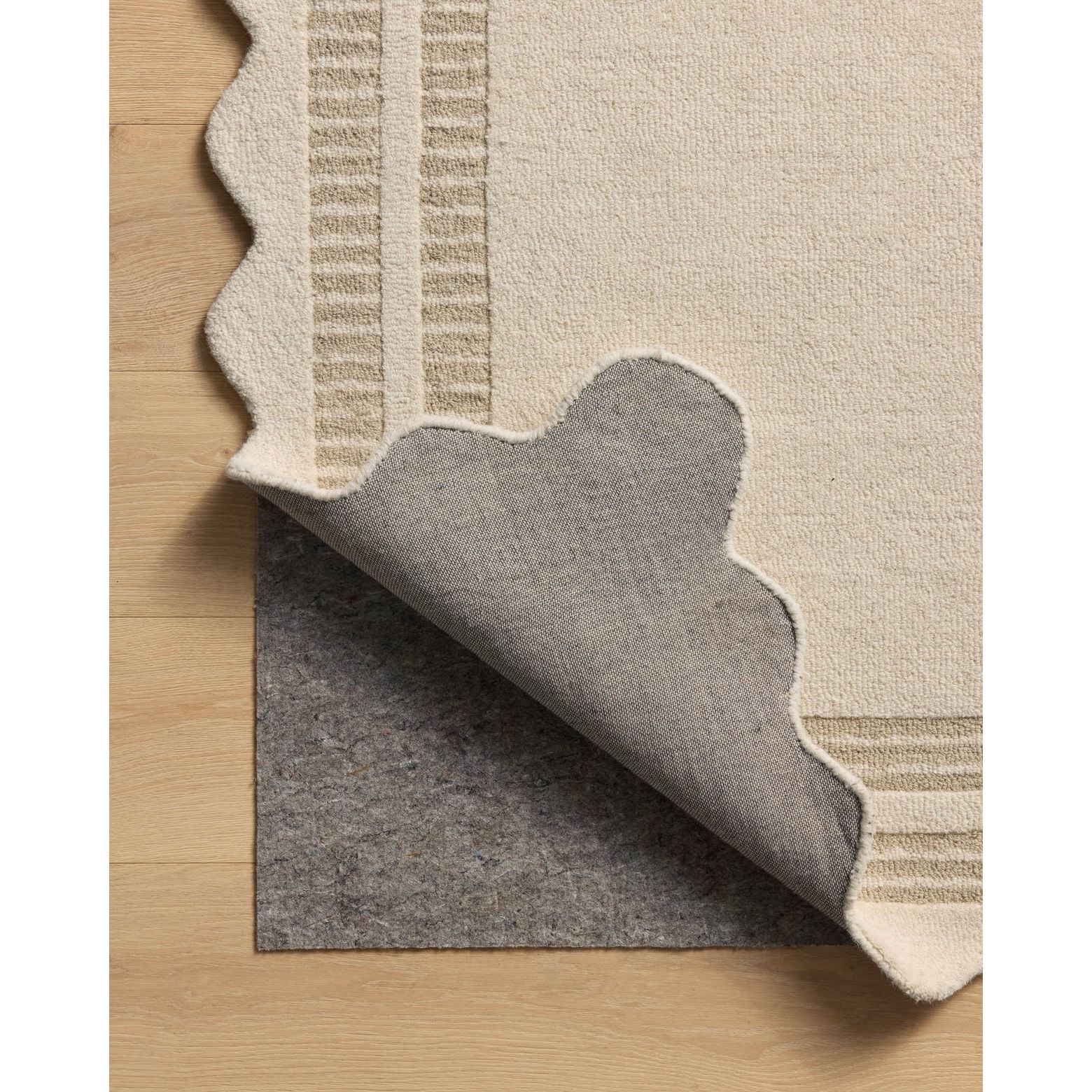 Featuring Chris Loves Julia × Loloi Scottie Ivory / Grey Rug by Loloi at Amethyst Home. The Scottie Collection from Chris Loves Julia x Loloi is a hand-tufted wool area rug with a playful scalloped edge and lower-pile, striped border for a touch of structure. The rugs overall pile is thick and plush, available in easygoing earth tones and neutral colorways. .  Amethyst Home provides interior design, new home construction design consulting, vintage area rugs, and lighting in the Seattle metro area.
