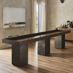 Featuring Shuffleboard Carbonized Black Table by Four Hands at Amethyst Home. This elevated shuffleboard table features a book-matched Guanacaste play surface with intricate laser-etched details, paired with steel and Guanacaste pucks. Aged metal accents highlight the design, all supported by three sleek, tapered bases. Regular care with shuffleboard waxes is required for optim. Amethyst Home provides interior design, new construction, custom furniture, and area rugs in the Laguna Beach metro area