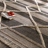 Bring a touch of global-inspired sophistication to your living space with the Cadiz Handmade Rug. This hand knotted wool rug has a plush pile, offering an inviting feel underfoot. The fringe detail adds texture and visual interest, while its Moroccan-style pattern gives this piece a timeless yet modern look. Amethyst Home provides interior design, new home construction design consulting, vintage area rugs, and lighting in the Charlotte metro area.