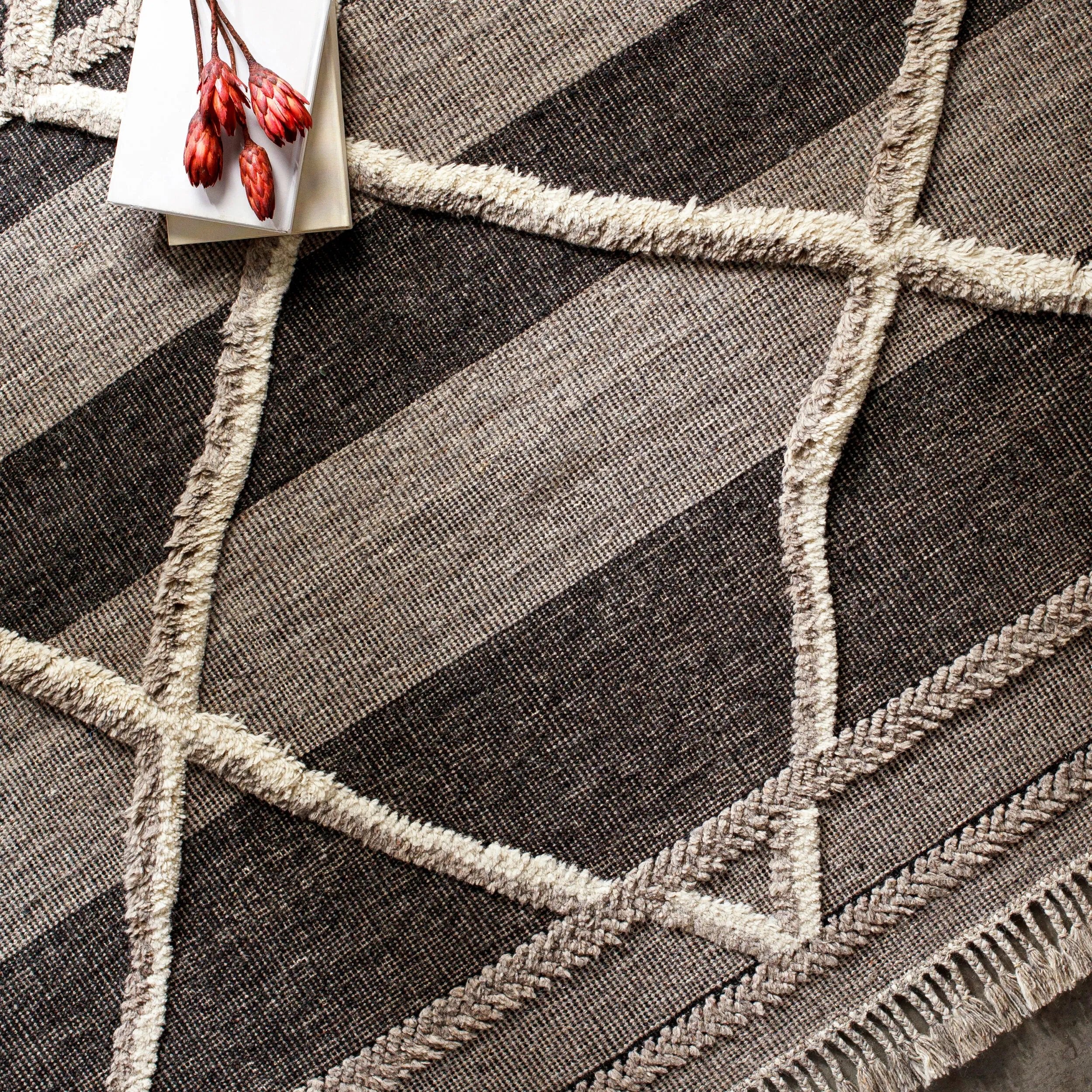 Bring a touch of global-inspired sophistication to your living space with the Cadiz Handmade Rug. This hand knotted wool rug has a plush pile, offering an inviting feel underfoot. The fringe detail adds texture and visual interest, while its Moroccan-style pattern gives this piece a timeless yet modern look. Amethyst Home provides interior design, new home construction design consulting, vintage area rugs, and lighting in the Laguna Beach metro area.