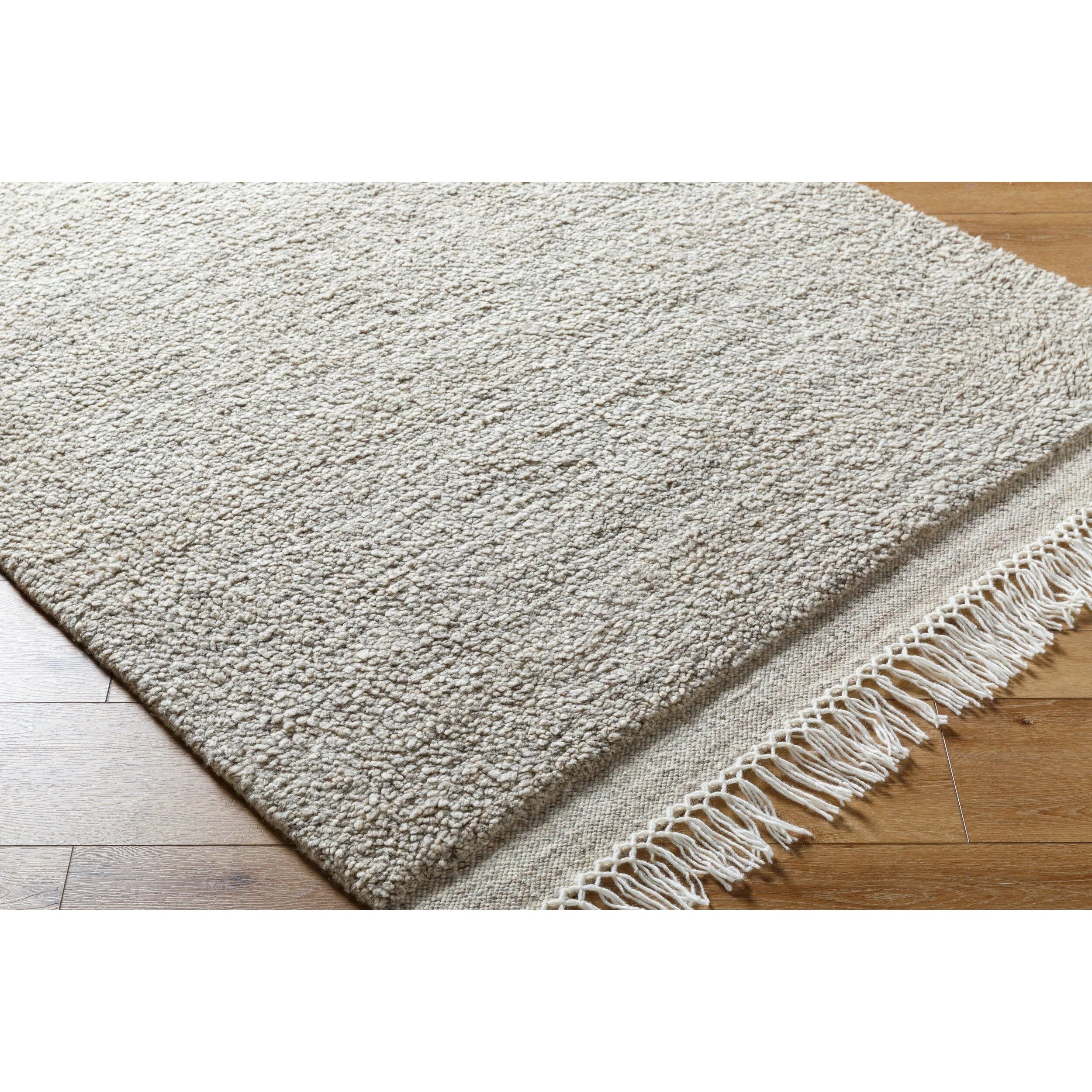 Introducing the Mabel Collection, where Country Cottage meets chic comfort. This handmade rug boasts a high pile construction, hand-woven from pure wool in the heartland of India, ensuring a plush and comfortable surface to walk on. It comes with an appealing fringe detail that adds a touch of rustic charm to any room. Amethyst Home provides interior design, new home construction design consulting, vintage area rugs, and lighting in the Tampa metro area.