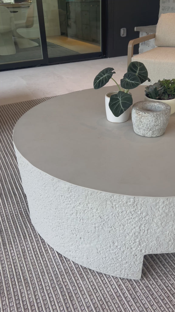 A textured, white concrete coffee table perfect for modern and wabi sabi style.  The table has a matte texture and is perfect for indoors or outdoors.Overall Dimensions: 48.00"w x 48.00"d x 16.25"hWeight : 277.78 lbsMaterials : Concrete Amethyst Home provides interior design, new home construction design consulting, vintage area rugs, and lighting in the Winter Garden metro area.