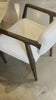 An angular distressed oak frame holds a cushioned seat and back. Upholstered in a soft and subtly fluffy faux shearling. Amethyst Home provides interior design, new home construction design consulting, vintage area rugs, and lighting in the Nashville metro area.