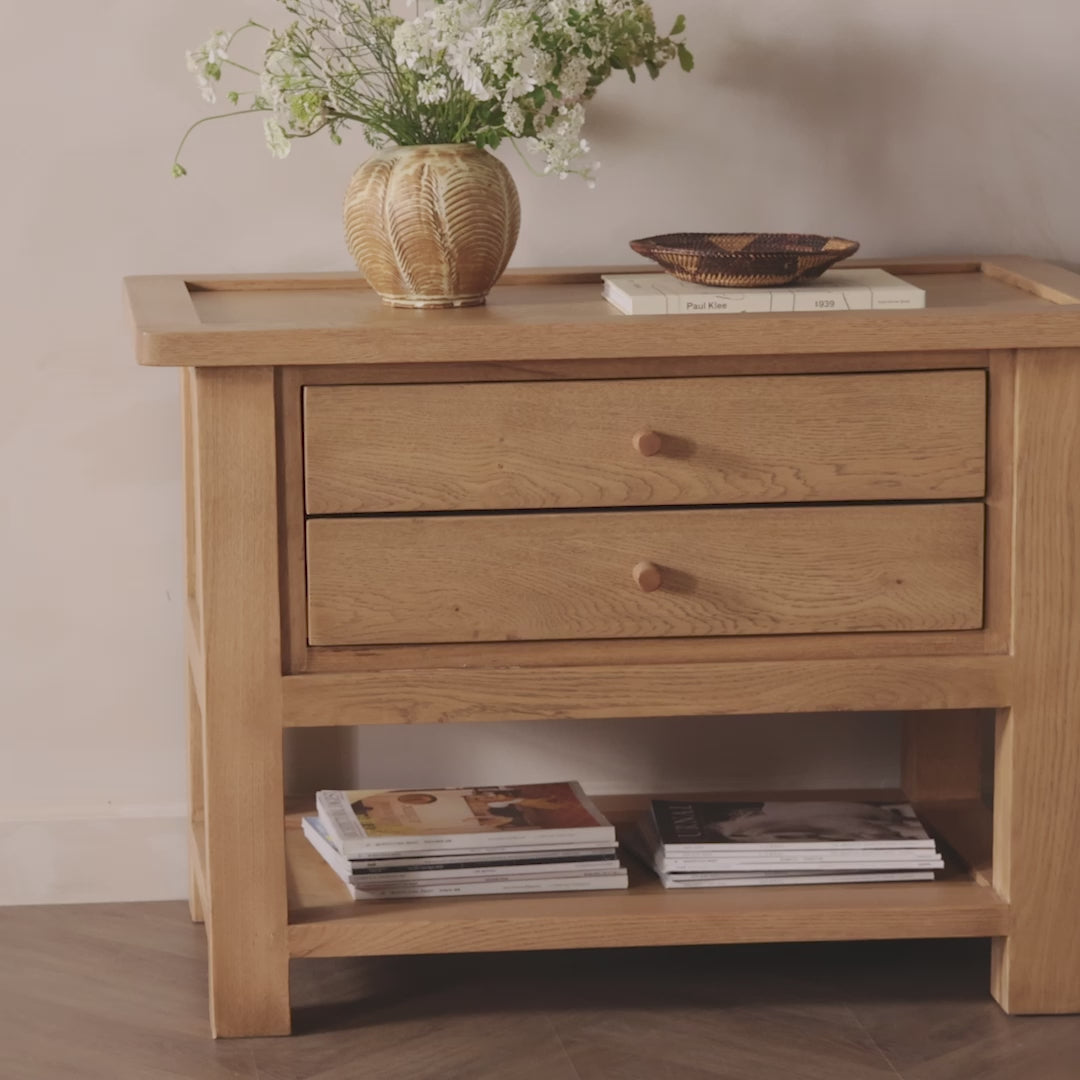 Made from light, natural oak, the design of this two-drawer nightstand is inspired by a vintage general store counter. Softened corners and simple knob complete its heritage charm.Overall Dimensions: 38.00"w x 22.00"d x 27.00"hWeight : 90.08 lbsMaterials : Oak Veneer, Solid Oak Amethyst Home provides interior design, new home construction design consulting, vintage area rugs, and lighting in the Laguna Beach metro area.