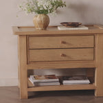Made from light, natural oak, the design of this two-drawer nightstand is inspired by a vintage general store counter. Softened corners and simple knob complete its heritage charm.Overall Dimensions: 38.00"w x 22.00"d x 27.00"hWeight : 90.08 lbsMaterials : Oak Veneer, Solid Oak Amethyst Home provides interior design, new home construction design consulting, vintage area rugs, and lighting in the Laguna Beach metro area.