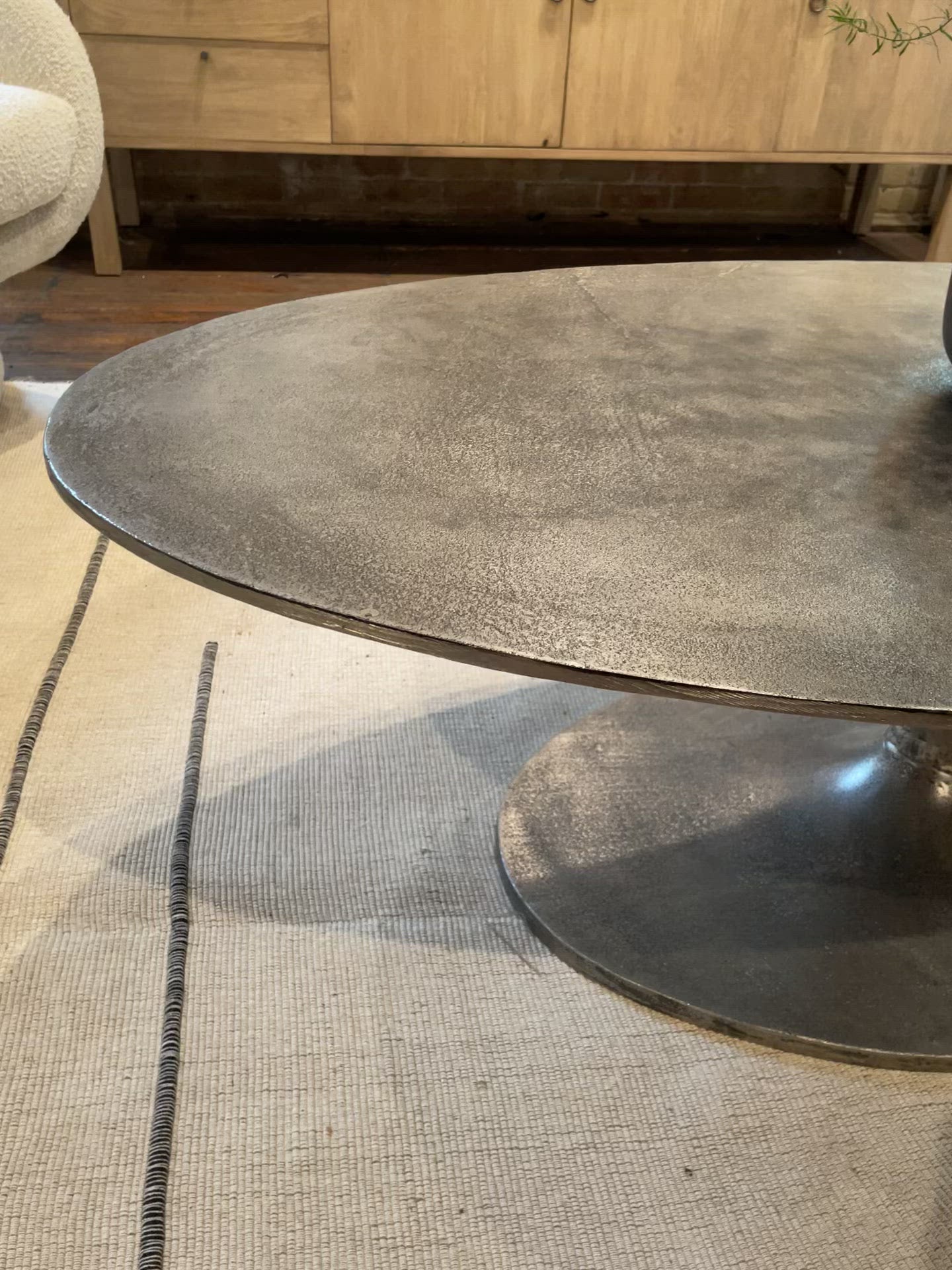 Load video: We love the oval shape of this Simone Coffee Table - Antique Nickel. The textural cast aluminum makes for a beautifully modern coffee table, with alluring highs and lows played up by a raw nickel finish. Great indoors or out; cover or store indoors during inclement weather and when not in use.  Overall Dimensions: 54.75&quot;w x 29.25&quot;d x 16.50&quot;h