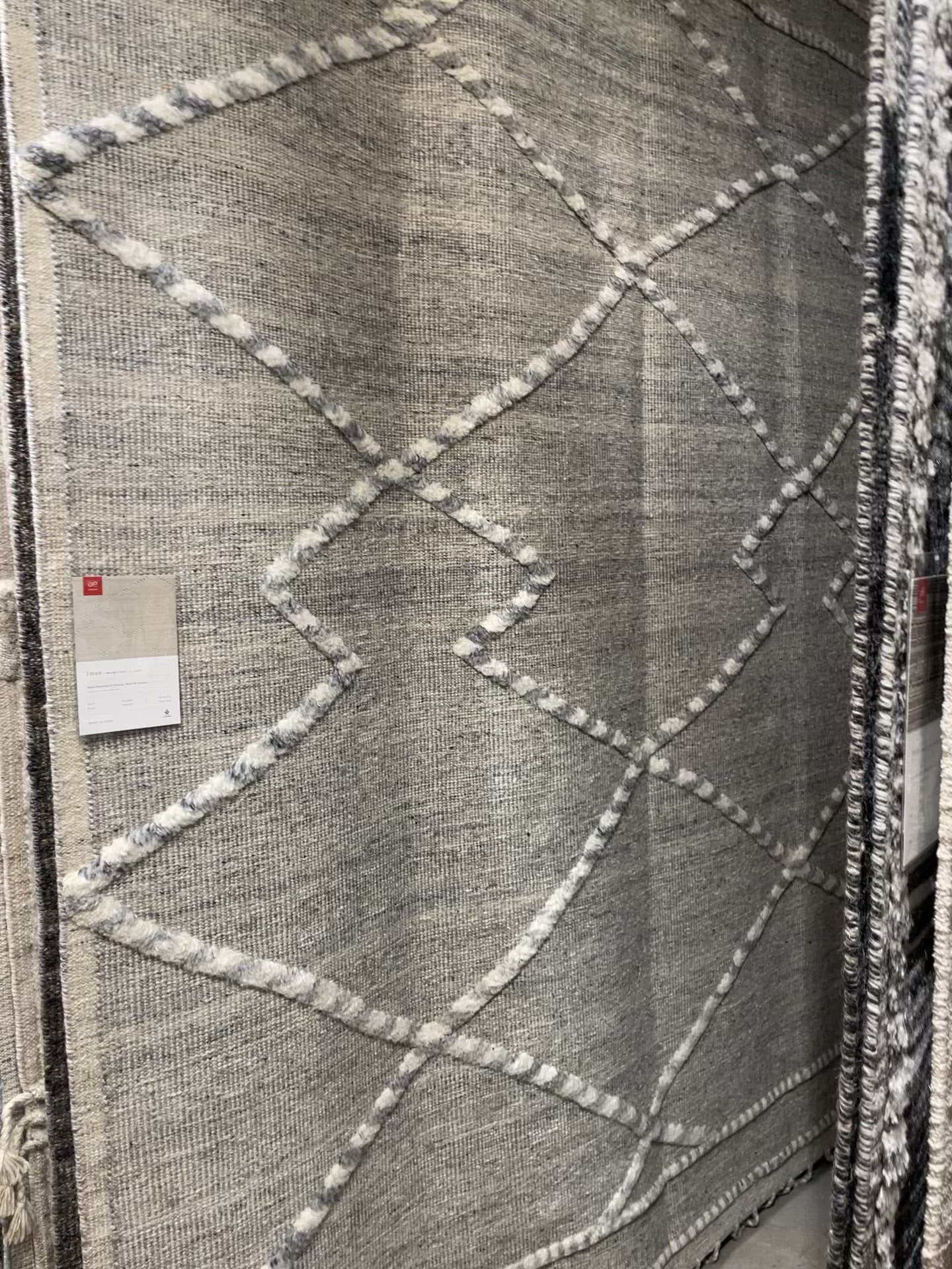 Load video: The Irvine Charcoal area rug from Loloi is hand-woven of wool, cotton, and polyester by artisans for a super comfortable rug. This rug is made from variegated yarns, fluffy bouclé texture, and has a twisted fringe border.  The Irvine rug lays a cozy foundation in a bedroom, living room, or family room for the perfect casual retreat. The rug has gorgeous tones of black, ivory, and pops of yellow for a cozy look. Crafted by Loloi for ED Ellen DeGeneres.  Hand Woven 81% Wool | 10% Cotton | 9% Polyester IRV-01 