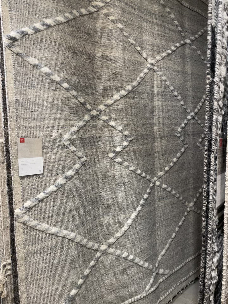 The Irvine Charcoal area rug from Loloi is hand-woven of wool, cotton, and polyester by artisans for a super comfortable rug. This rug is made from variegated yarns, fluffy bouclé texture, and has a twisted fringe border.  The Irvine rug lays a cozy foundation in a bedroom, living room, or family room for the perfect casual retreat. The rug has gorgeous tones of black, ivory, and pops of yellow for a cozy look. Crafted by Loloi for ED Ellen DeGeneres.  Hand Woven 81% Wool | 10% Cotton | 9% Polyester IRV-01 