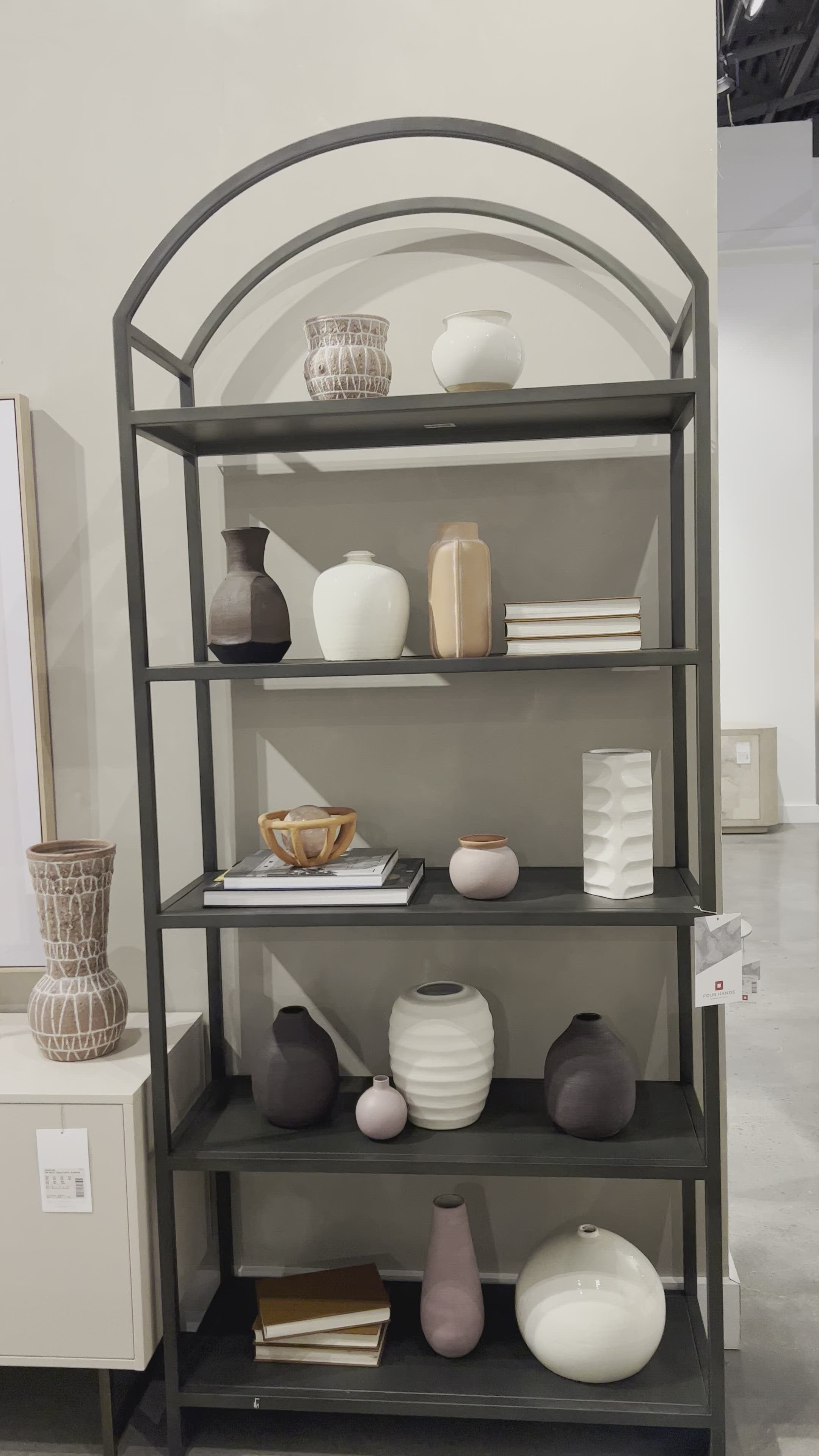 Load video: This Loomis Bookcase - Black is sleek, simple and beautifully on-trend. Black-finished iron forms an airy open frame, with an arched top for modernity in any office, living, or other space! Amethyst Home provides interior design, new home construction design consulting, vintage area rugs, and lighting in the Kansas City metro area.