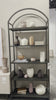 This Loomis Bookcase - Black is sleek, simple and beautifully on-trend. Black-finished iron forms an airy open frame, with an arched top for modernity in any office, living, or other space! Amethyst Home provides interior design, new home construction design consulting, vintage area rugs, and lighting in the Kansas City metro area.