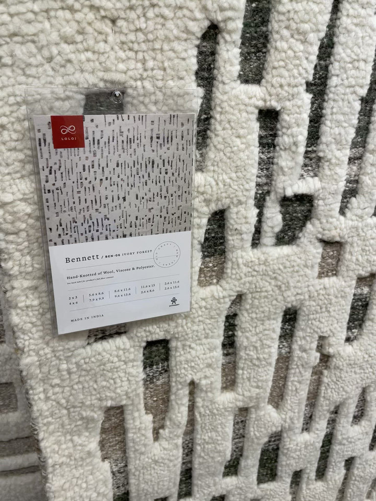 Dimensional yet soft, the Bennett Ivory / Charcoal Area Rug is hand-knotted of wool, viscose and polyester in India. Featuring a new carve like high-low pile, Bennett has an ivory base with abstract tonal designs. Plus, it's plush underfoot -- a great choice for your office, bedroom, or other medium traffic areas.   Hand Knotted 45% Wool | 32% Viscose | 17% Polyester | 6% Other Fibers Pile BEN-01 Ivory/Charcoal