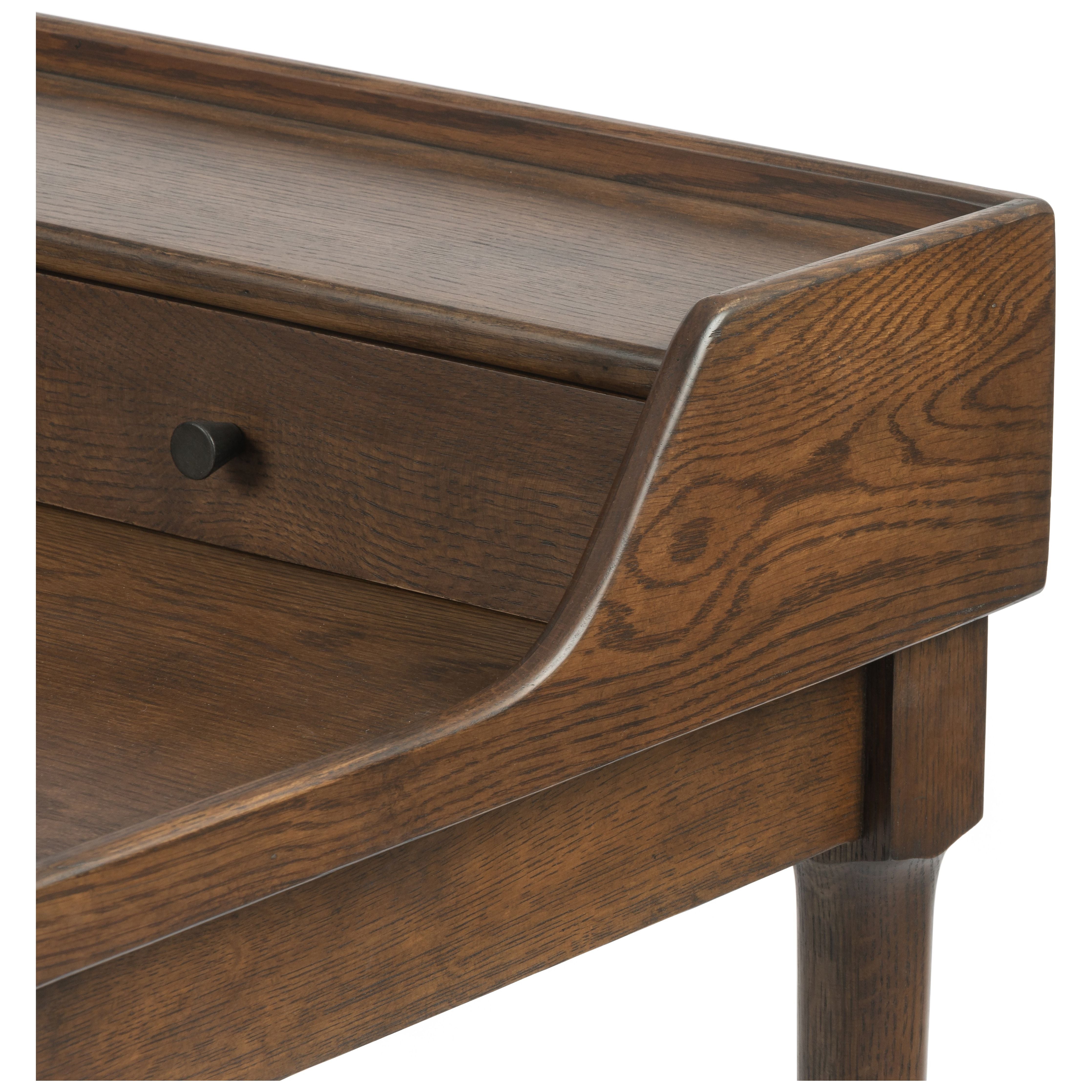 Dark-toasted oak's rich brown finish speaks to mid-century inspiration, while plenty of storage meets the needs of a modern office with this Moreau Dark Toasted Oak Writing Desk.   Overall Dimensions: 48"w x 23.5"d x 34.75"h