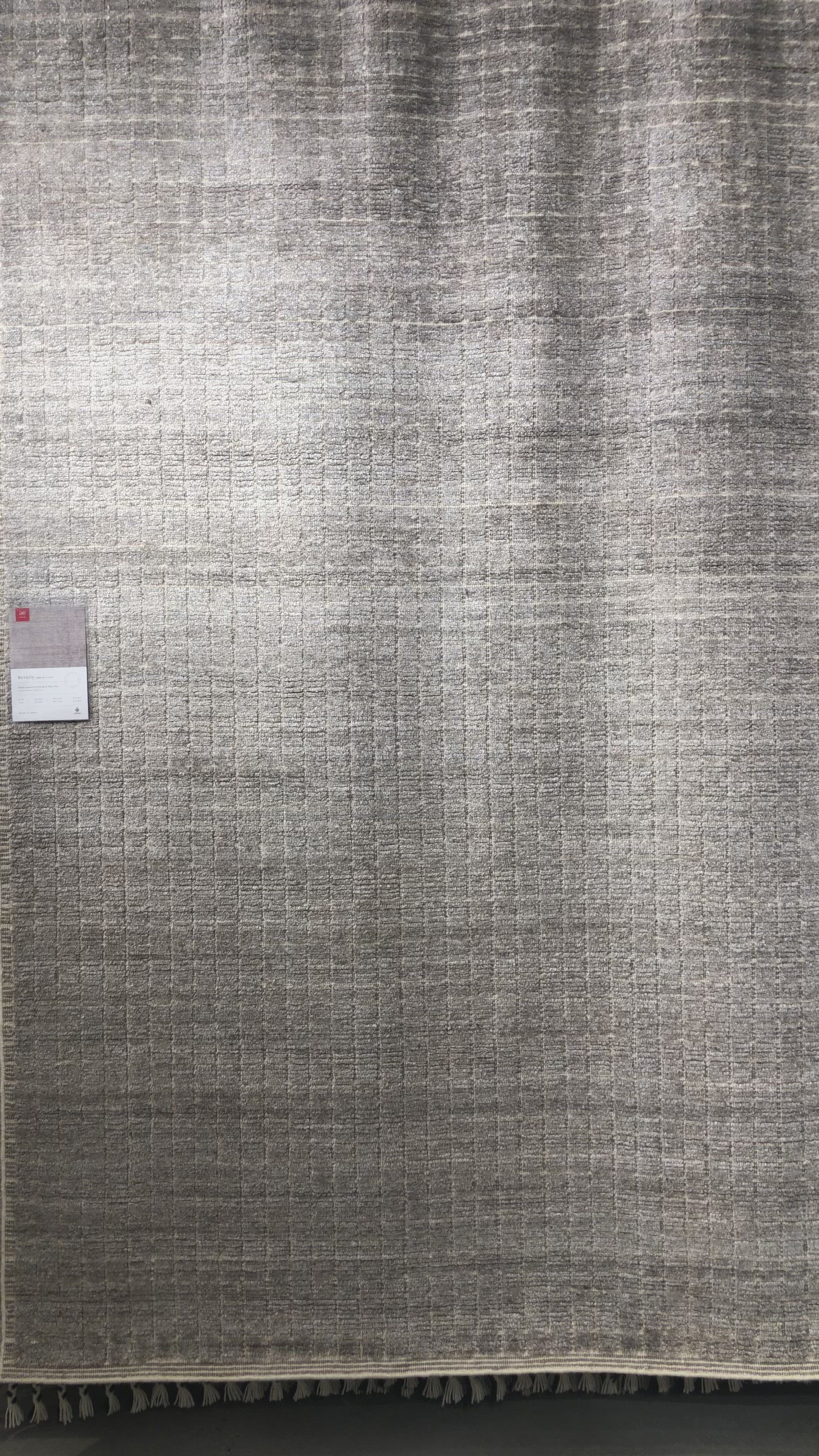 Load video: Modern and refined, the Beverly Stone rug by Loloi is hand-loomed by master artisans of viscose and wool pile. Clean lines and minimalist hues allow you to layer Beverly into any room.  Hand Loomed 45% Viscose | 26% Wool | 20% Cotton | 7% Polyester | 2% Other Fibers BEV-01 Stone