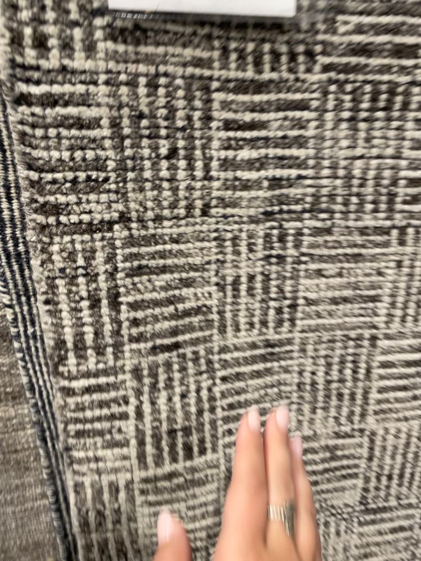 The Rize Mugler Area Rug offers intricate and delicately designed global patterns to the modern home. A thatched square motif creates an eye-catching geometric design on the artistically distressed Mugler area rug. In an earthy ivory and black colorway, this durable hand-knotted wool accent blends a timeless craft with contemporary charm.  Hand Knotted 100% Wool RIZ05