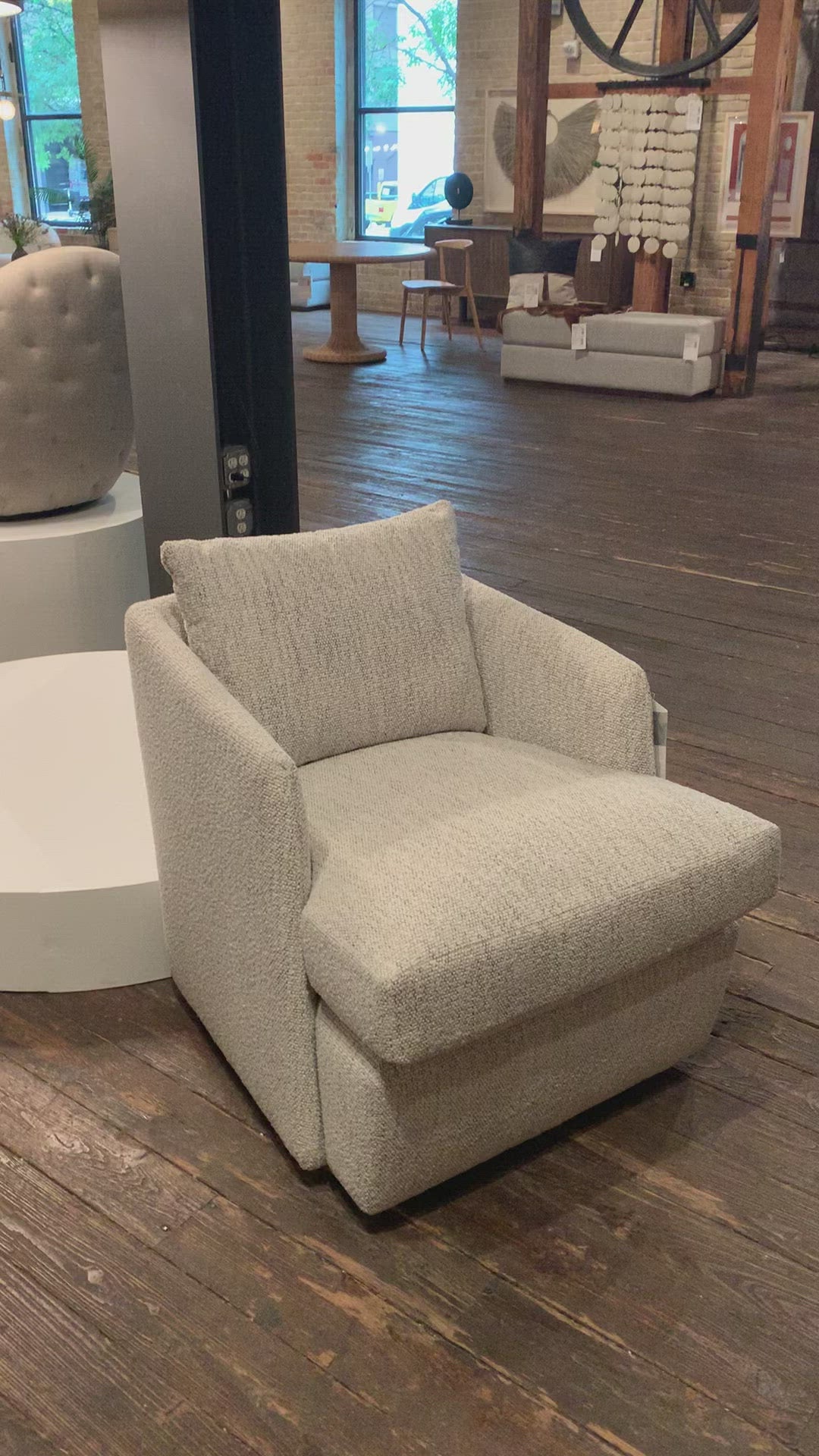 Load video: This Whittaker Swivel Chair - Merino Cotton is a comfortable classic. Atop a 360-degree swivel base, well-tailored cotton seating provides a beautifully simple place to perch in style, with feather-blend cushioning for total relaxation -- the perfect chair for a baby room, living room, or other area.   Overall Dimensions: 28.75&quot;w x 35.00&quot;d x 35.50&quot;h
