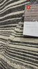 Iman Ivory/Charcoal Rug - Amethyst Home A new take on Moroccan style rugs, the Iman Collection is hand-knotted of 100% wool pile by skilled artisans in India. The surface features linear and braided details, creating tonal variations that make each piece unique. Plus, each design is finished with playful fringe.