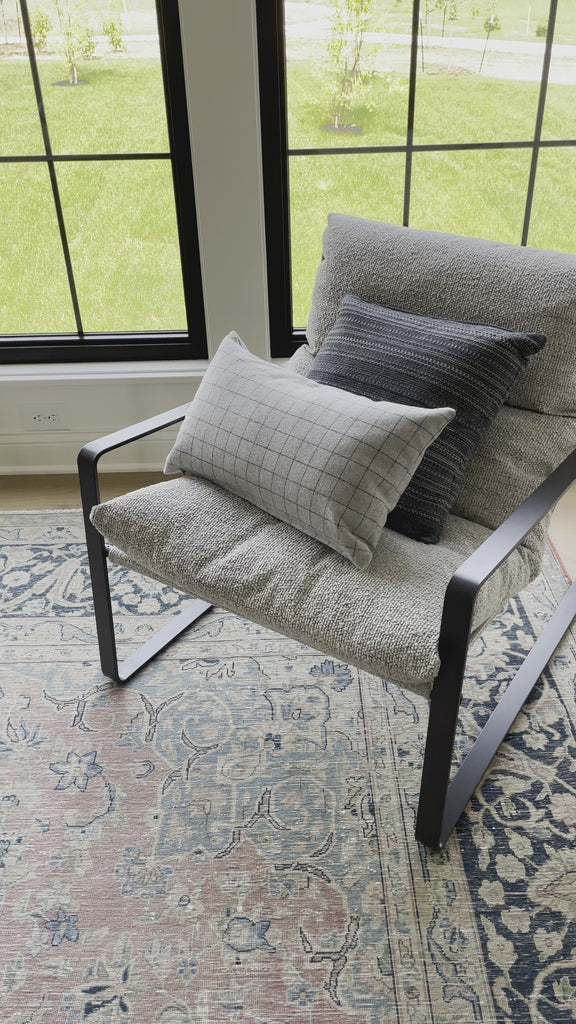 Super stylish, effortlessly cool, this Emmett Sling Chair - Merino Porcelain is upholstered with beautifully chunky seagrass texture and a sling-style seating that sits low and curved for a fresh take on a throwback form. Industrial gunmetal-finished iron framing turns up the drama one more notch for any living room, office, or other space.   Overall Dimensions: 29.00"w x 36.00"d x 29.00"h