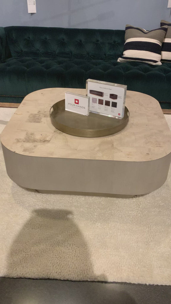 Made from bleached ash burl, this Blanco Coffee Table - Bleached Burl is a soft-squared tabletop featuring a patchwork pattern to bring novel movement to the modern coffee table. Finished in an ashen walnut, mahogany veneer sides and an inset base complete a beautifully light look for any living room or lounge area.   Overall Dimensions: 40.00"w x 40.00"d x 16.00"h