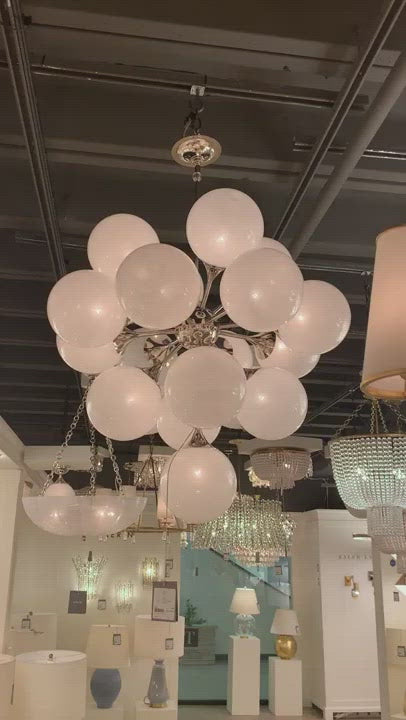 We love the white strie glass globes on this Cristol Large Chandelier by Visual Comfort. It brings a stunning and unique look to any living room, dining room, or kitchen.  Designer: AERIN