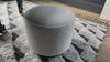 This round ottoman of textural cream boucle can be placed just about anywhere, bringing with it a hip retro vibe.  Size: 22" w x 22" d x 18.5" h  Colors: Distressed Natural, Knoll Natural Materials: Solid Parawood, 95% Polyester, 5% Pc   