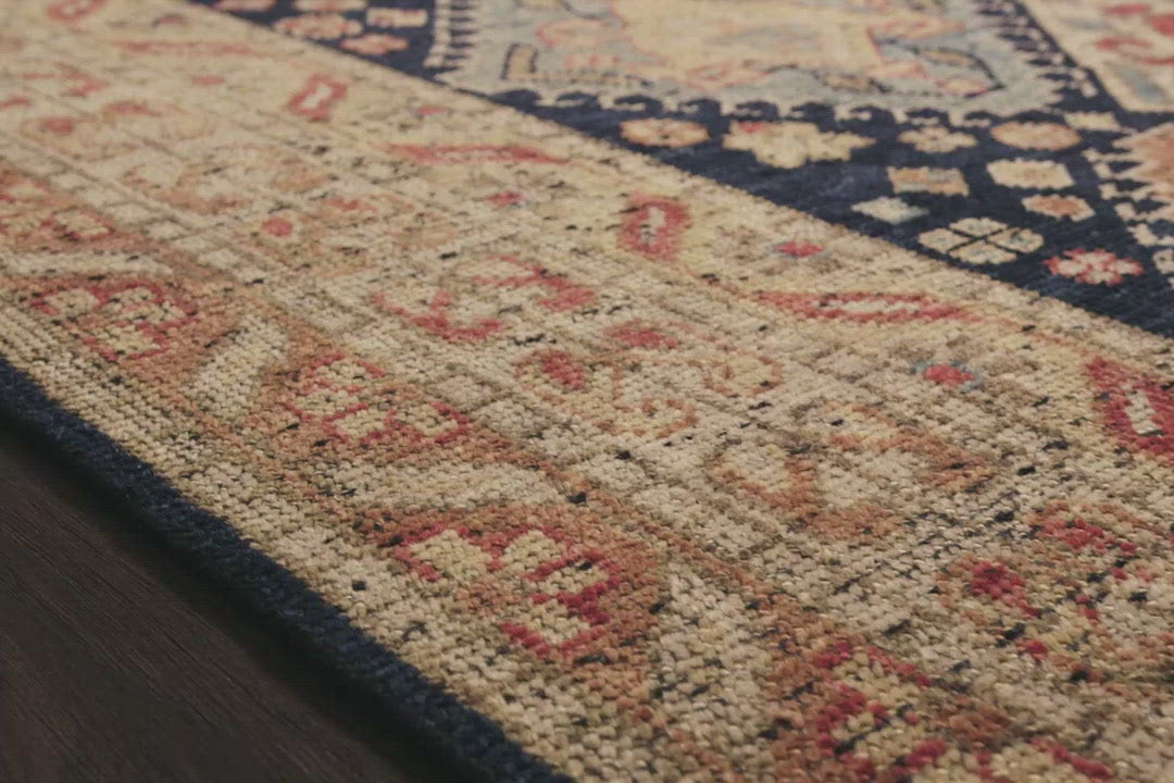 Load video: Bring a touch of antiqued beauty into your home with our Heirloom collection. This 100% wool collection tastefully honors the art of hand knotted rugs from India. Heirloom evokes a sense of unique sophistication with its traditional Serapi rug color palettes and vintage design.  Hand Knotted 87% Wool | 13% Cotton HQ-01 Navy/Multi