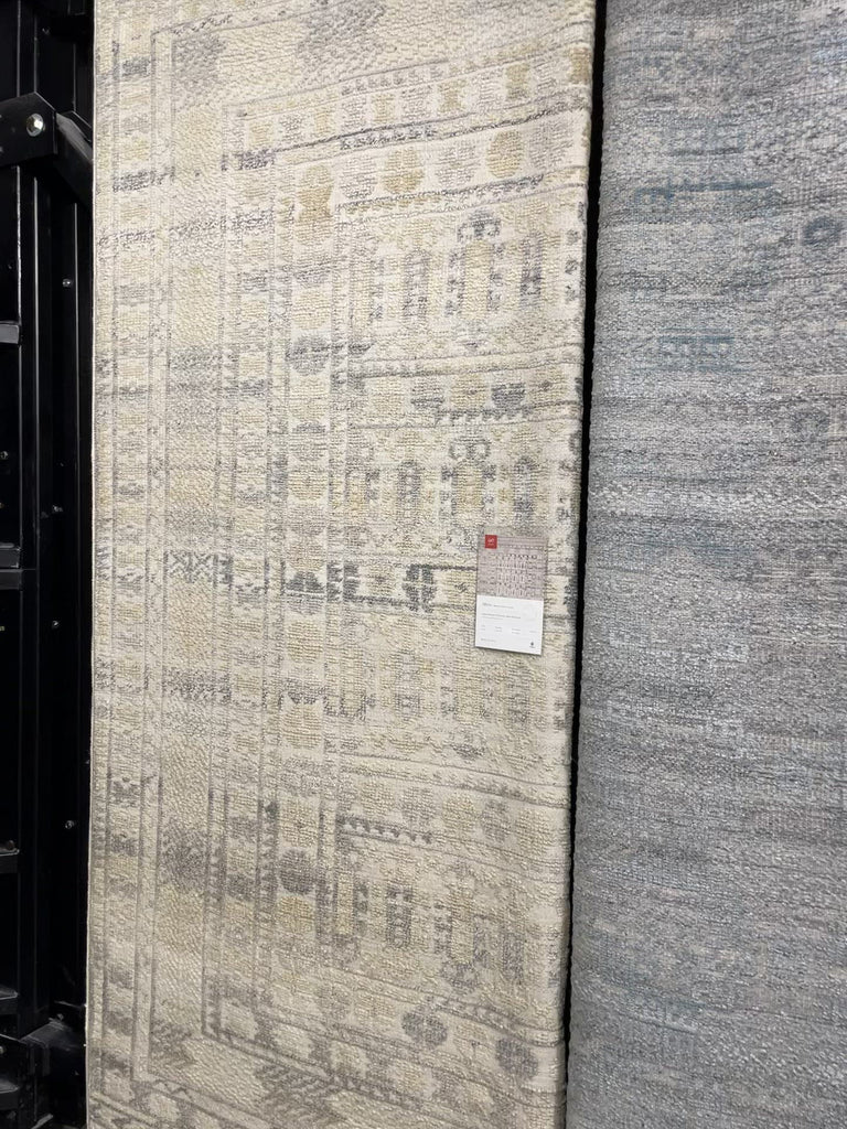 The Idris Ivory/Taupe area rug from Loloi is meticulously hand-knotted of viscose and wool. You will love this rug because the rug is:  Perfect for entryways, living rooms, and bedrooms Easy to clean and maintain Gorgeous with the intricate pattern and patina Warms up any room with the high / low pile Hand-Knotted 70% Viscose | 30% Wool ID-04 Ivory/Taupe