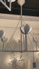The Alberto Large Single Tier Chandelier by Visual Comfort has gorgeous, thin arms with a stunning flower placed atop each head. This gives a unique, bright look to any dining room, living room, or other large area.  Designer: Julie Neill