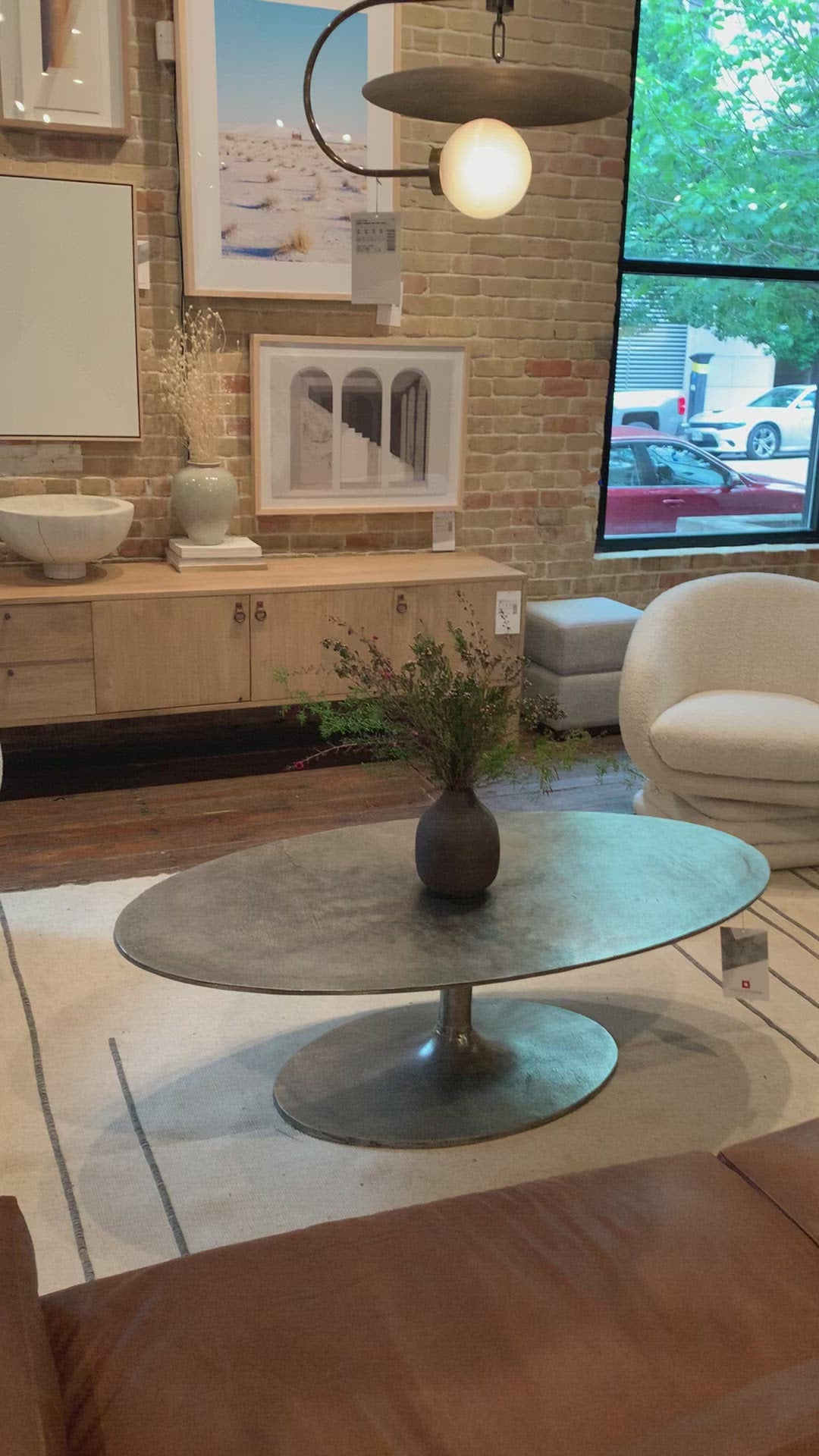 Load video: We love the oval shape of this Simone Coffee Table - Antique Nickel. The textural cast aluminum makes for a beautifully modern coffee table, with alluring highs and lows played up by a raw nickel finish. Great indoors or out; cover or store indoors during inclement weather and when not in use.  Overall Dimensions: 54.75&quot;w x 29.25&quot;d x 16.50&quot;h