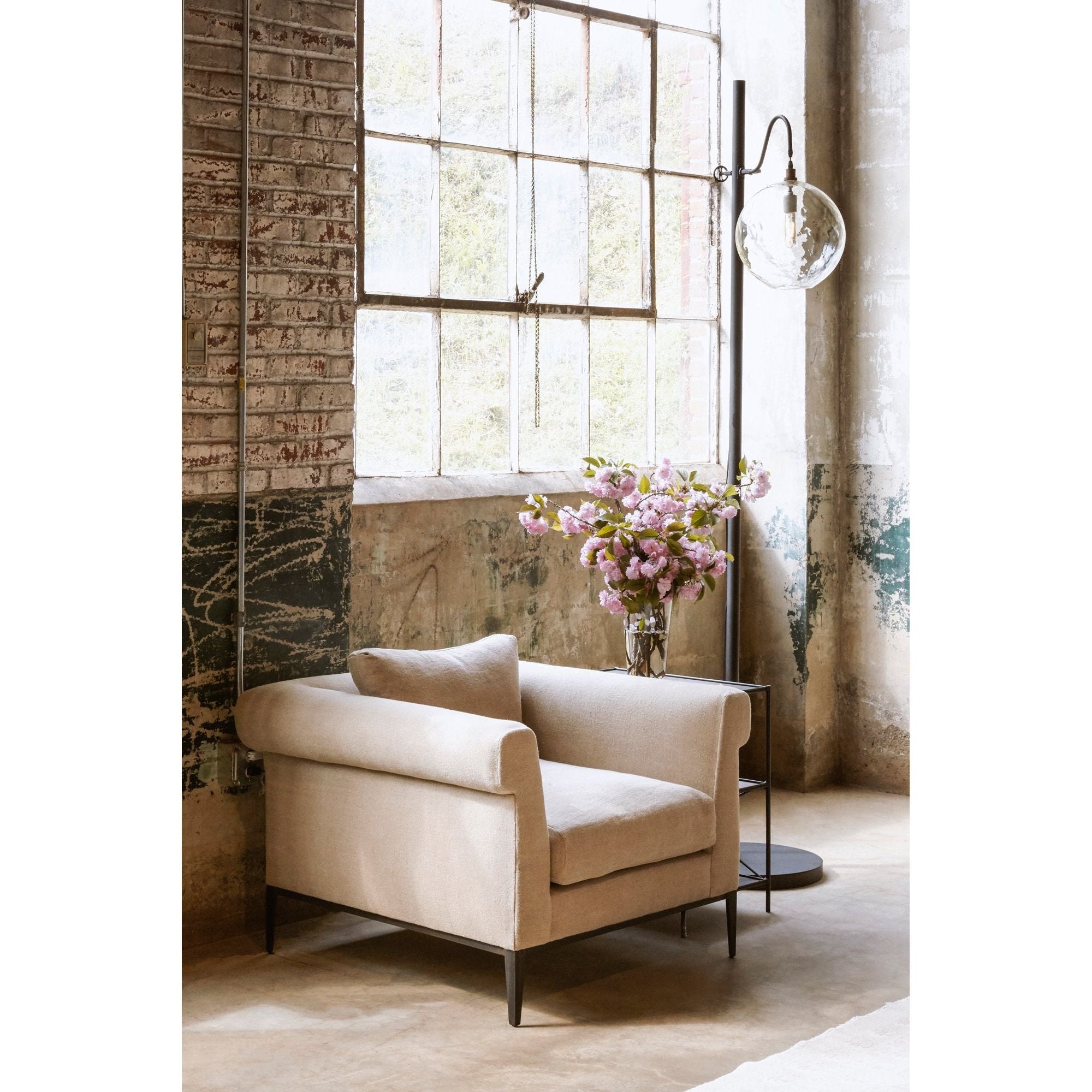 The Aurora Lamp from Cisco Brothers adds a chic light to any room. Each lamp is hand blown glass and can vary up to 1" in size. The light fixture can be height adjusted upon the metal rod to fit right where you need it. The lamp can come in a globe, bailey medium lamp, or bailey small lamp.