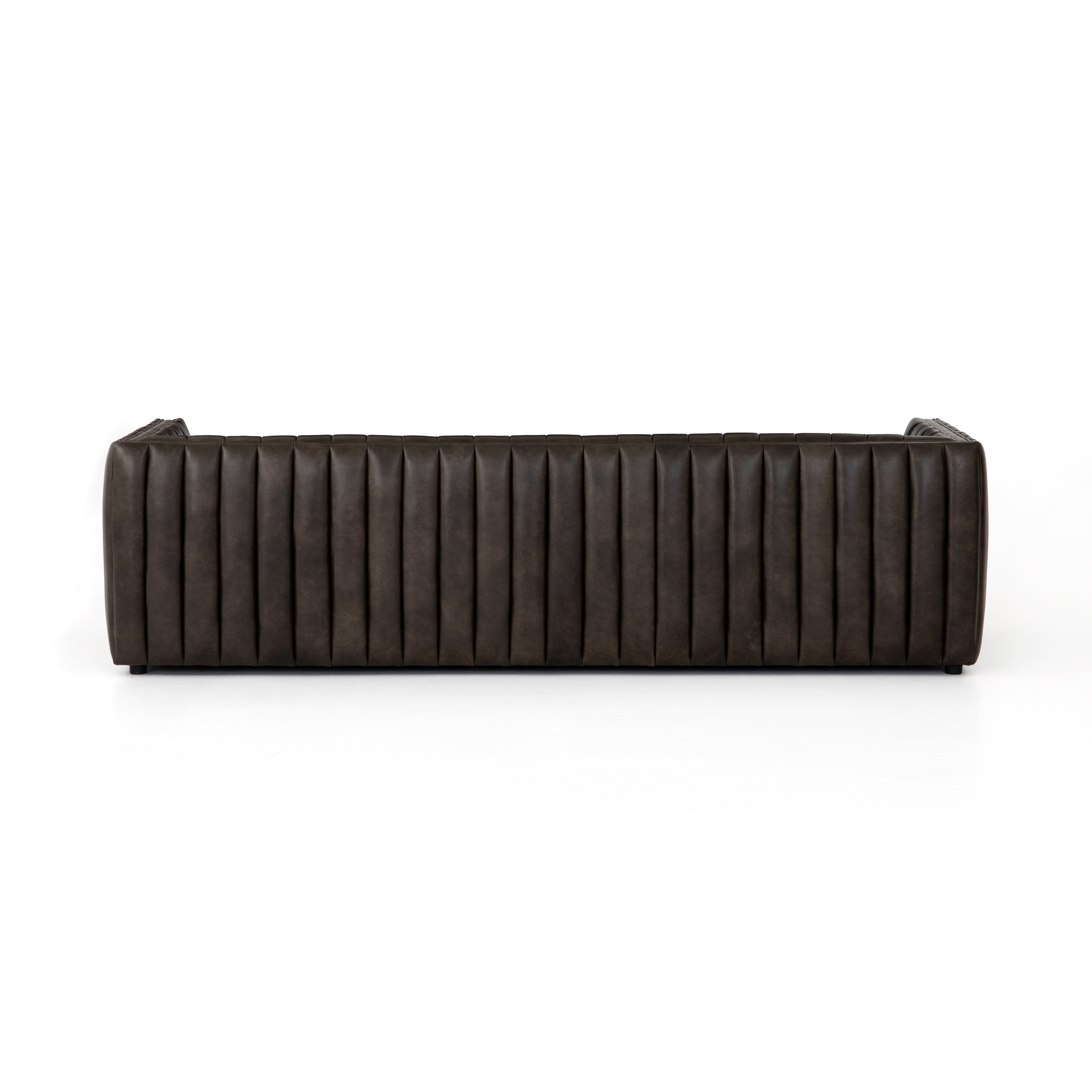 Featuring Henry Wolf Leather Sofa 97" by Four Hands at Amethyst Home. Upholstered in dreamy "wolf" leather -- this sofa is the perfect blend of chocolate and grey tones.  Channeled leather makes for a structured, comfortable sit.  
The Amethyst design team often recommends this sofa when you need a narrower depth without sacrificing comfort.  This sofa sea.  Amethyst Home provides interior design, new home construction design consulting, vintage area rugs, and lighting in the Charlotte metro area.