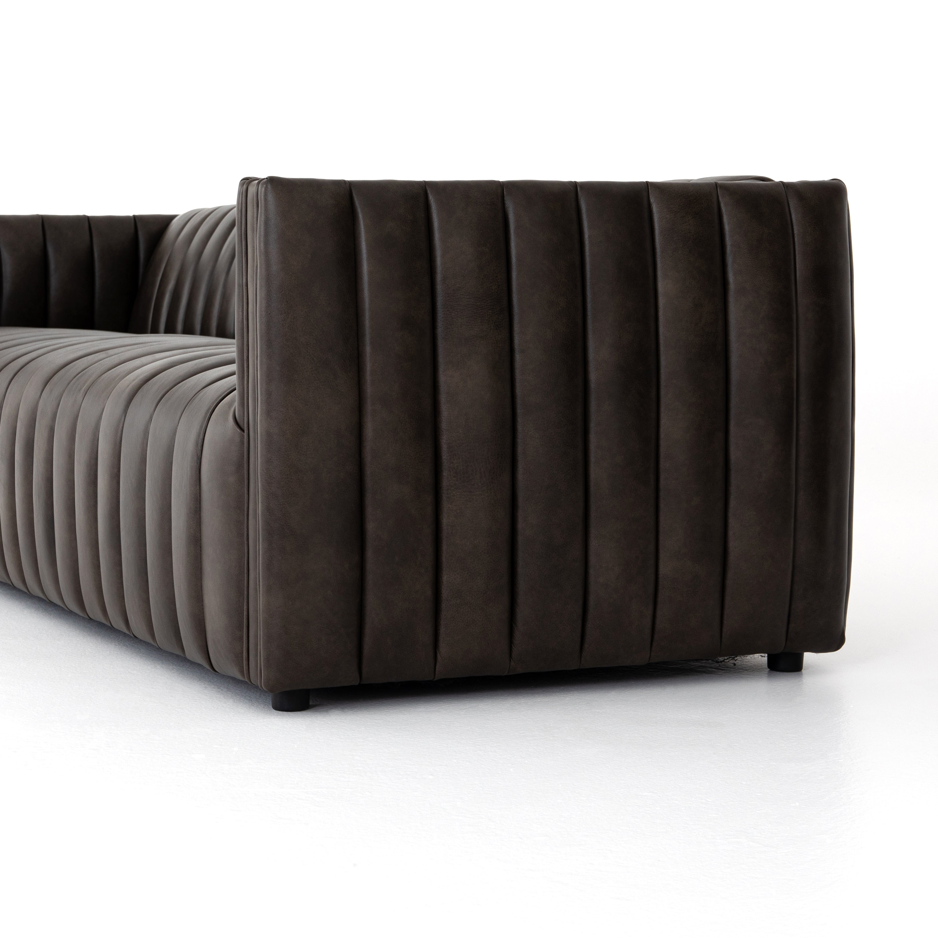Featuring Henry Wolf Leather Sofa 97" by Four Hands at Amethyst Home. Upholstered in dreamy "wolf" leather -- this sofa is the perfect blend of chocolate and grey tones.  Channeled leather makes for a structured, comfortable sit.  
The Amethyst design team often recommends this sofa when you need a narrower depth without sacrificing comfort.  This sofa seat.  Amethyst Home provides interior design, new home construction design consulting, vintage area rugs, and lighting in the Portland metro area.