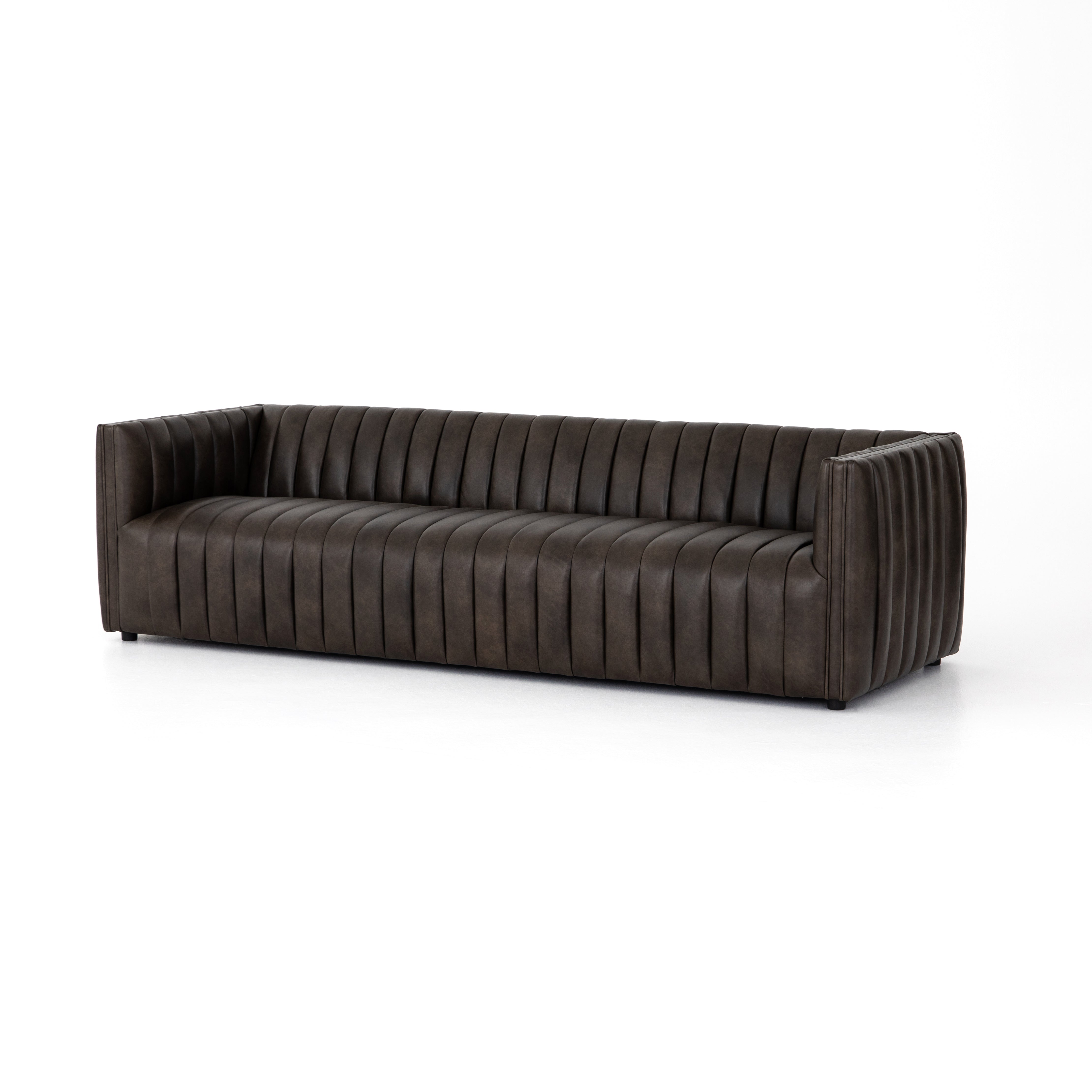 Featuring Henry Wolf Leather Sofa 97" by Four Hands at Amethyst Home. Upholstered in dreamy "wolf" leather -- this sofa is the perfect blend of chocolate and grey tones.  Channeled leather makes for a structured, comfortable sit.  
The Amethyst design team often recommends this sofa when you need a narrower depth without sacrificing comfort.  This sofa sea.  Amethyst Home provides interior design, new home construction design consulting, vintage area rugs, and lighting in the Charlotte metro area.