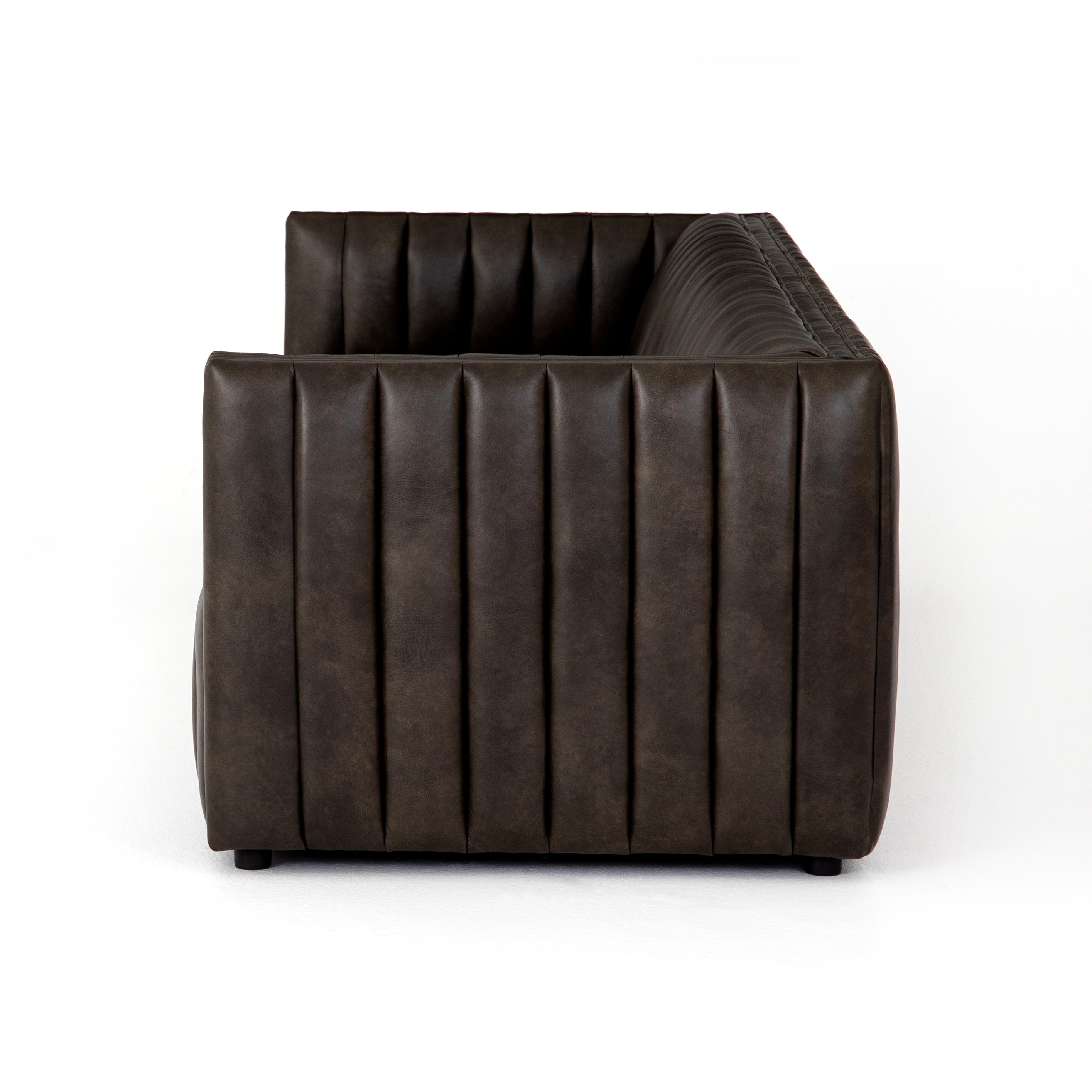 Featuring Henry Wolf Leather Sofa 97" by Four Hands at Amethyst Home. Upholstered in dreamy "wolf" leather -- this sofa is the perfect blend of chocolate and grey tones.  Channeled leather makes for a structured, comfortable sit.  
The Amethyst design team often recommends this sofa when you need a narrower depth without sacrificing comfort.  This sofa seat.  Amethyst Home provides interior design, new home construction design consulting, vintage area rugs, and lighting in the Portland metro area.