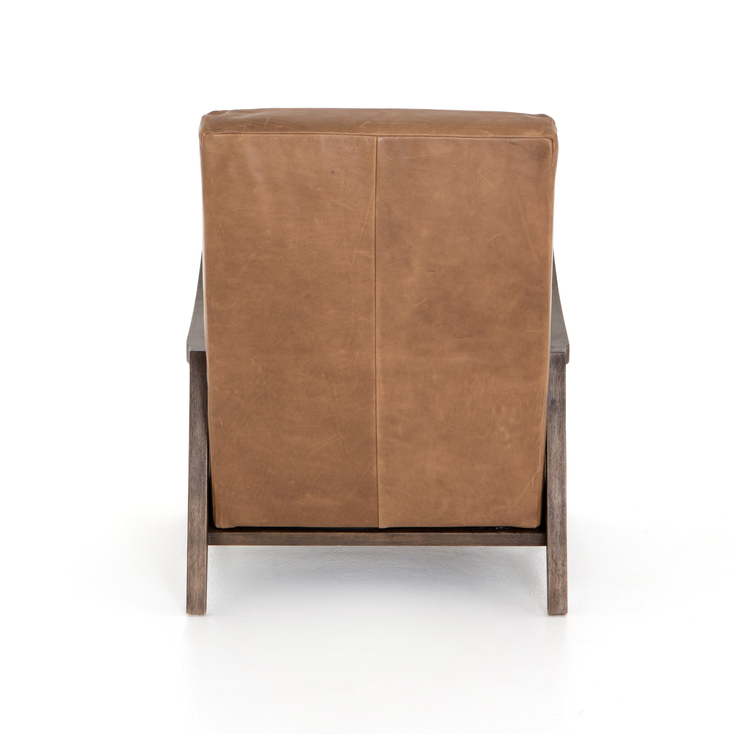 The Chance Recliner has an invitingly curved seat with dramatic horizontal channels is covered in soft, camel-colored top-grain leather. Rich, tonal frame captures alluring negative—and positive—spaces. A push recliner takes this forward-thinking lounger to the next level.  Overall Dimensions: 27.50"w x 56.00"d x 36.00"h Seat Depth: 20.25" Seat Height: 18" Arm Height from Floor: 24" Arm Height from Seat: 6"