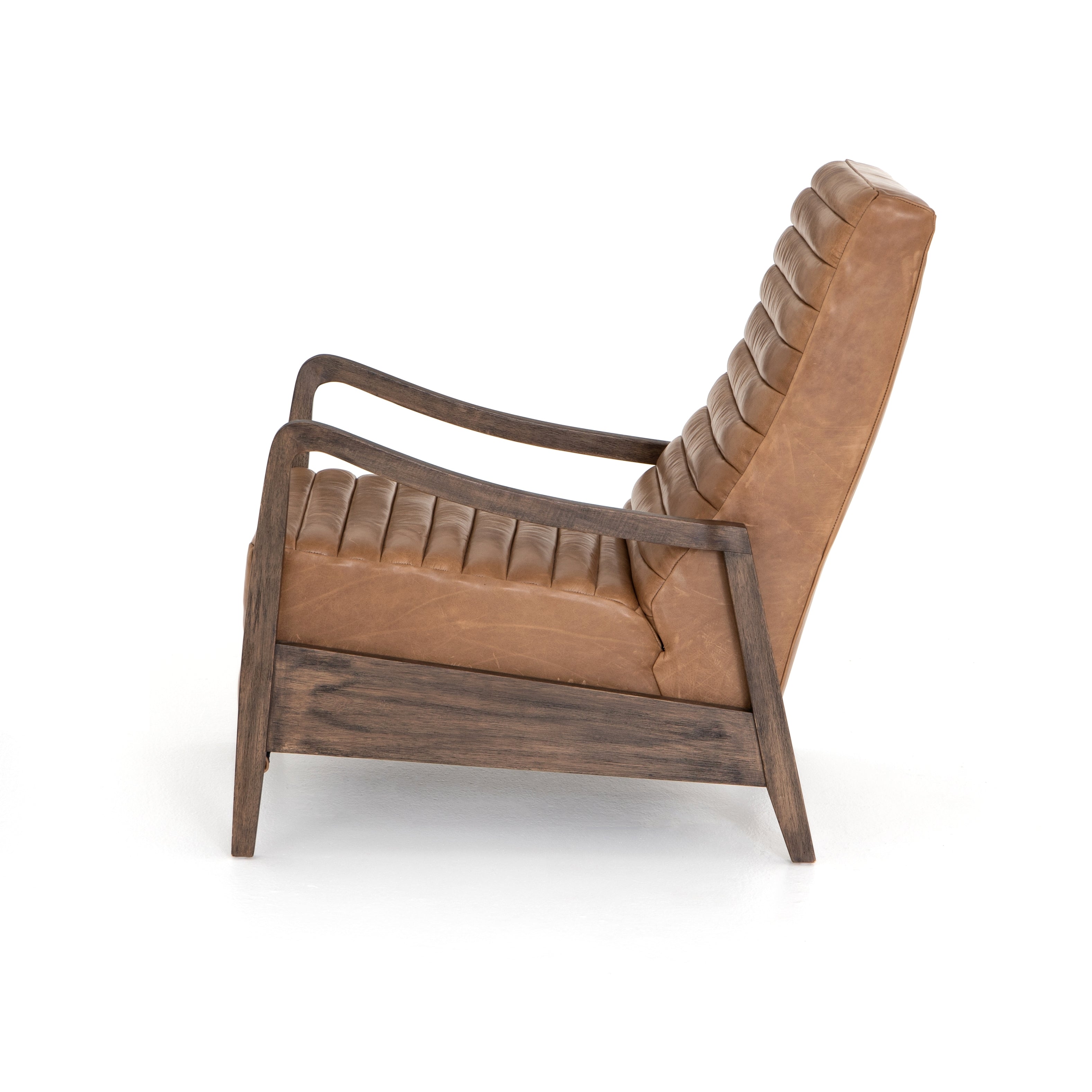 Featuring Chance Warm Taupe Dakota Leather Recliner by Four Hands at Amethyst Home. The Chance Recliner has an invitingly curved seat with dramatic horizontal channels is covered in soft, camel-colored top-grain leather. Rich, tonal frame captures alluring negative—and positive—spaces. A push recliner takes this forward-thinking lounger to the next level.  Amethyst Home provides interior design, new home construction design consulting, vintage area rugs, and lighting in the Los Angeles metro area.