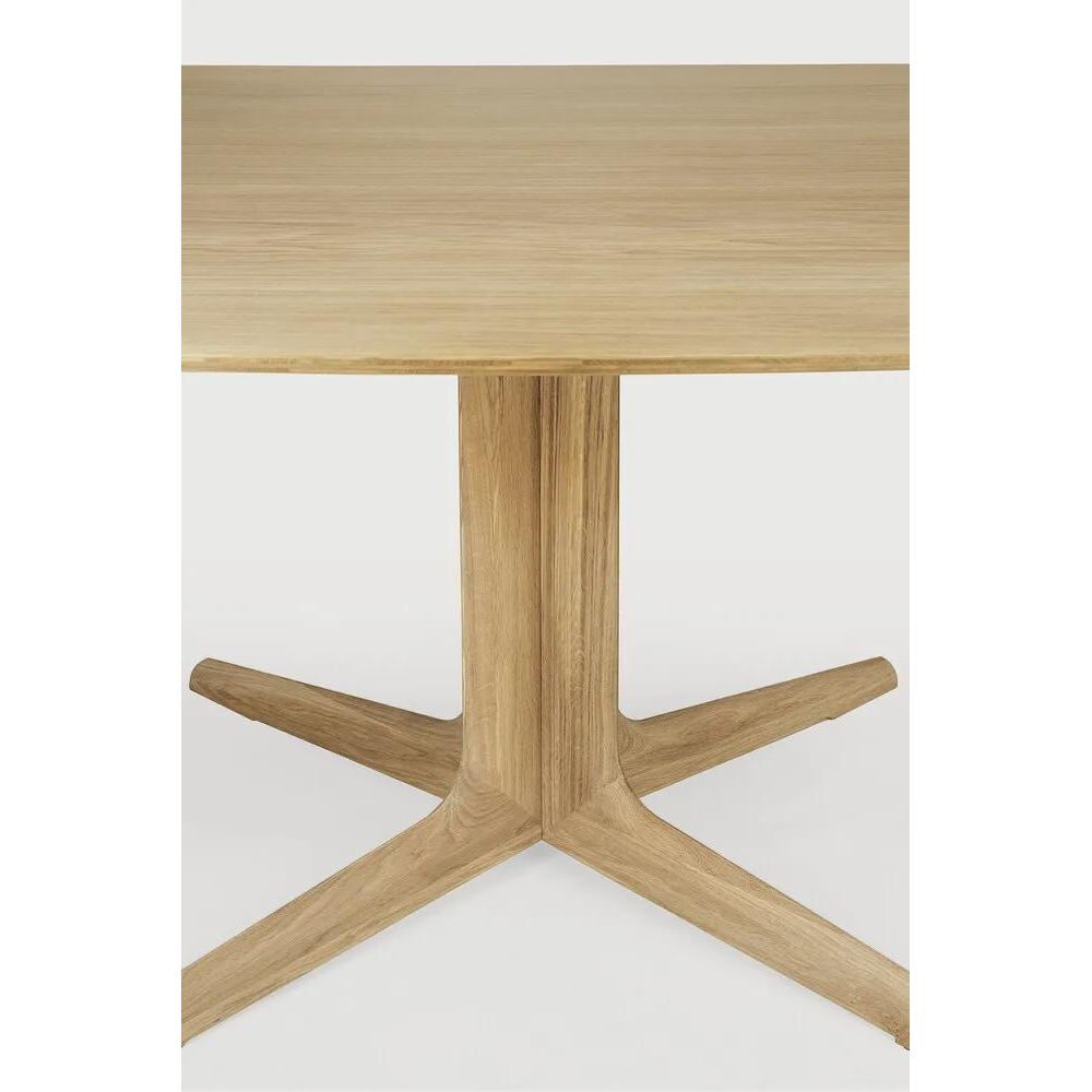Featuring Corto Dining Table by Ethnicraft at Amethyst Home. Inspired by the vaults within grand architectural designs, the Corto's central-footed base provides both visual interest and practical stability with less leg disturbance for your guests. The solid oak tabletop is crafted into the perfect shape, with unique rounded corners to create welcoming and . Amethyst Home provides interior design, new home construction design consulting, vintage area rugs, and lighting in the San Diego metro area.