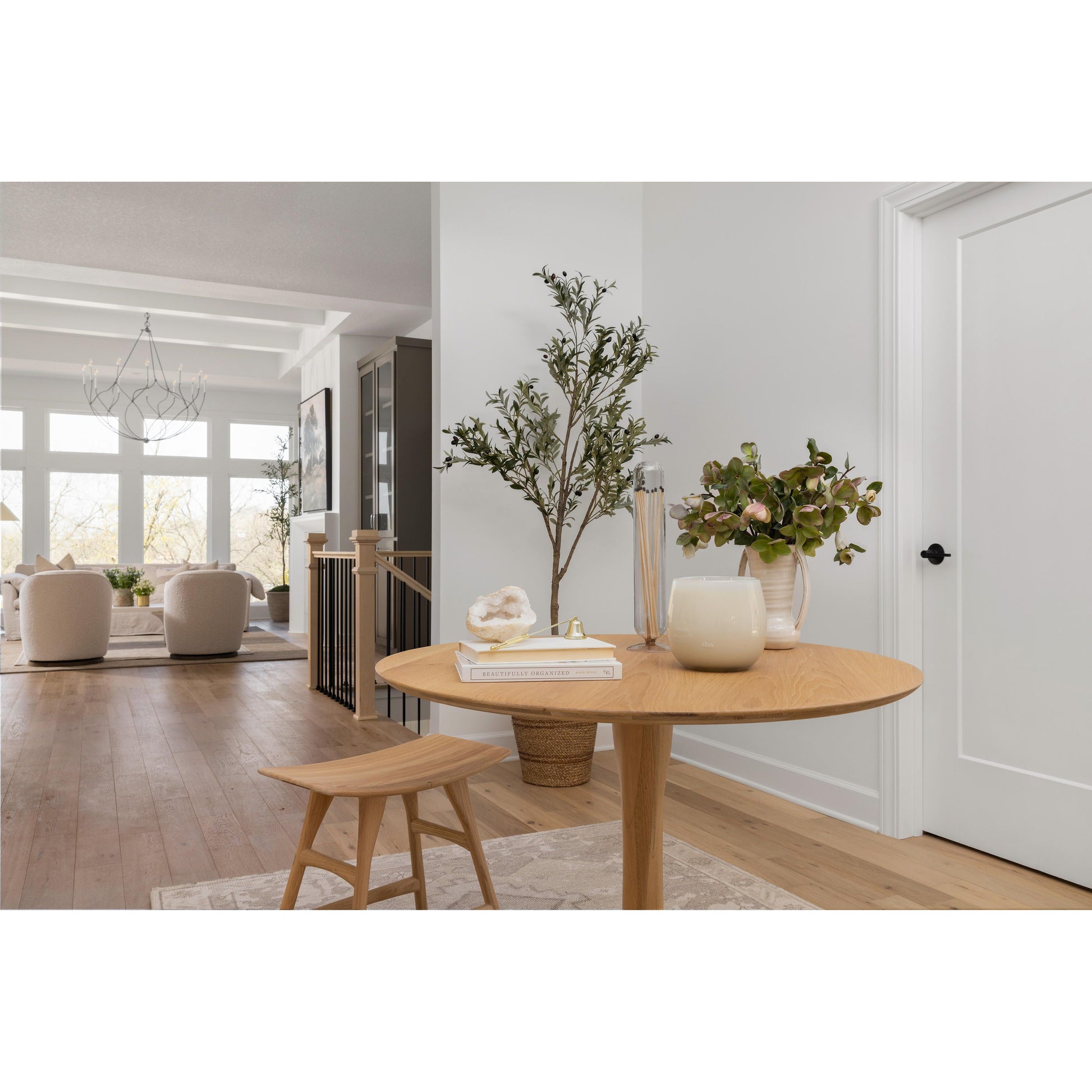 Experience the airy elegance of the Oak Round Torsion Dining Table. it adds a touch of sophistication to any dining or kitchen area. Enhance your space with sconce ideas and complement it with vertical shiplap or tongue and groove walls for a modern coastal or cottage design. The Sherwin Williams Library Pewter and Pure White finishes bring refinement to California farmhouse, Utah home design, and Nashville home design. Perfect for kitchens, living rooms, entryways, foyers, offices, and bedrooms.