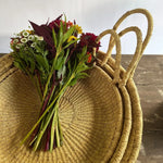 Our new trays from Ghana are here! Made of tightly woven wild grasses in a classic natural tone, these round trays are great for use throughout the home and garden. Sizes are averages, as these are all handmade items. Amethyst Home provides interior design services, furniture, rugs, and lighting in the Kansas City metro area.