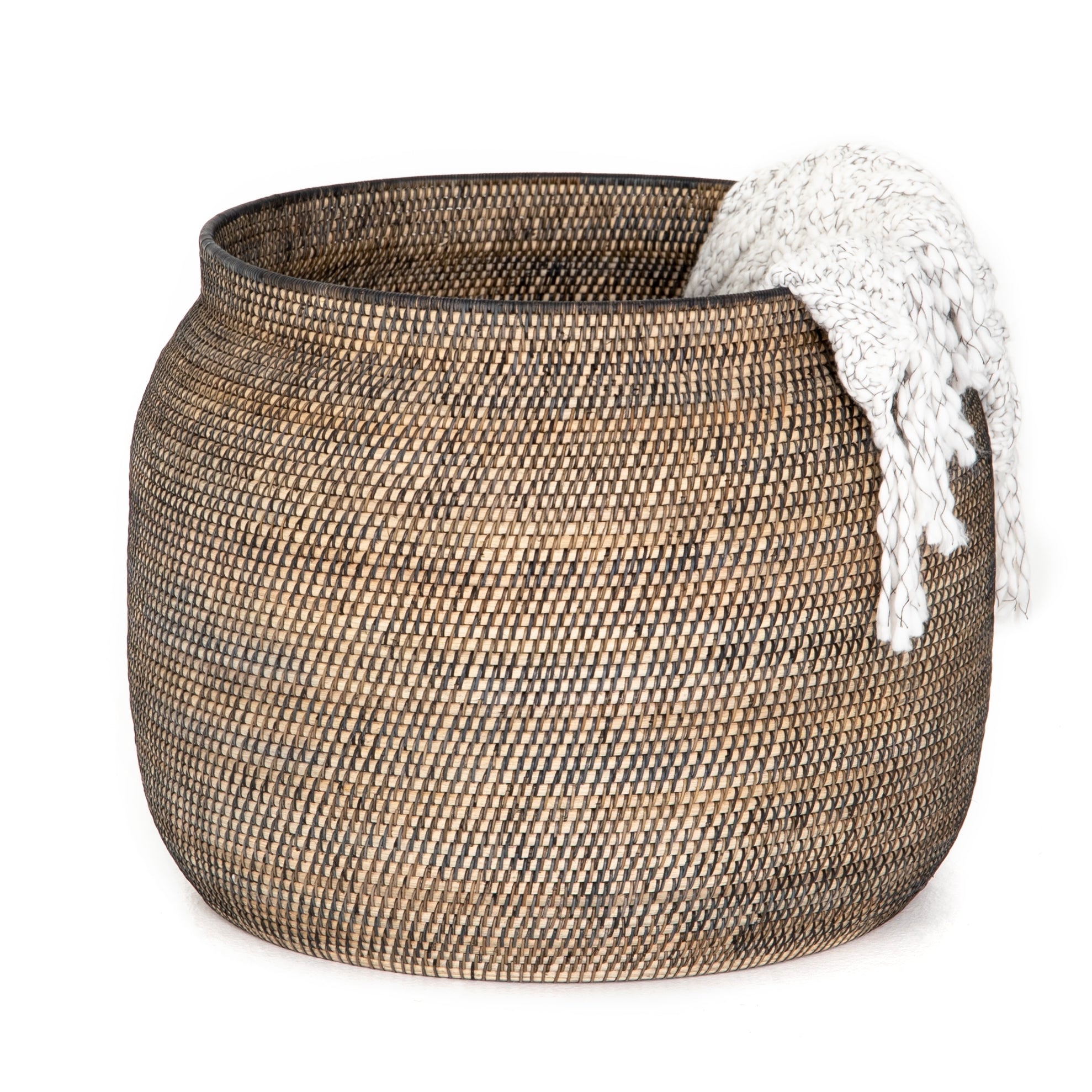 This Ansel Contrast Black Basket is woven from natural Lombok and black rattan, bringing a gorgeous color and texture to the basket. A large, stylish basket to store your pet toys, blankets, or other items around the home.   Overall Dimensions: 24.00"w x 24.00"d x 18.50"h Colors: Natural Lombok Weave, Black Rattan Materials: Lombok, Rattan