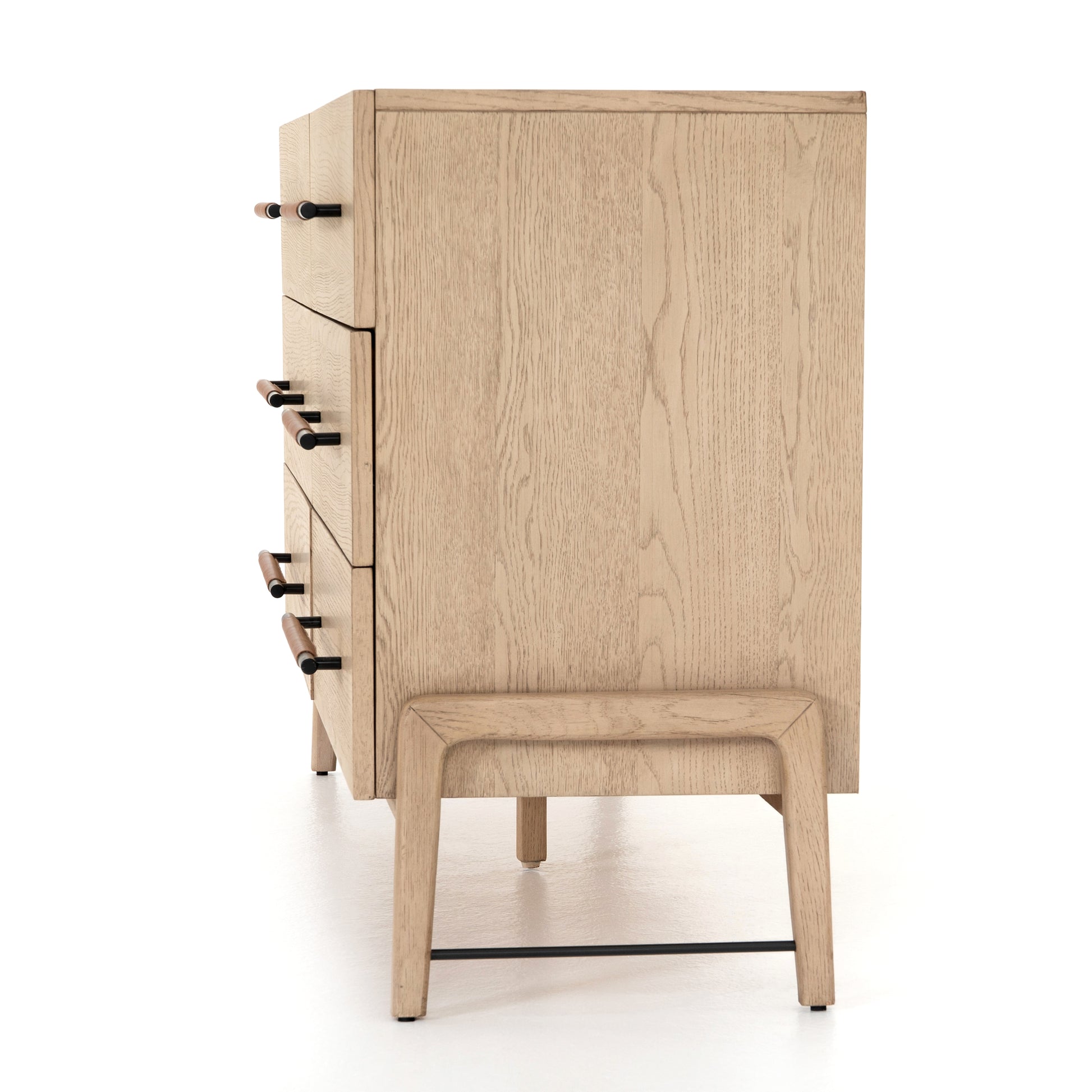 The light-finished oak of this Rosedale 6 Drawer Dresser brings a clean, brightness to any room. With six spacious drawers and iron hardware wrapped in a gorgeous, tan leather,  this is a functional and beautiful piece to add to your bedroom or other area.   Overall Dimensions: 62.50"w x 19.50"d x 33.00"h Materials: Oak Veneer, Top Grain Leather, Iron, Solid Oak