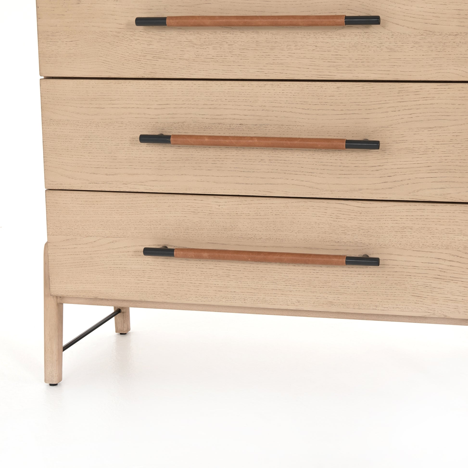 The light-finished oak of this Rosedale 6 Drawer Tall Dresser brings a clean, brightness to any room. With four large drawers and two smaller drawers, this is a functional and beautiful piece to add to your bedroom or other area. The iron hardware wrapped in a gorgeous, tan leather really seals the deal!   Overall Dimensions: 36.50"w x 19.50"d x 49.25"h Materials: Oak Veneer, Top Grain Leather, Iron, Solid Oak