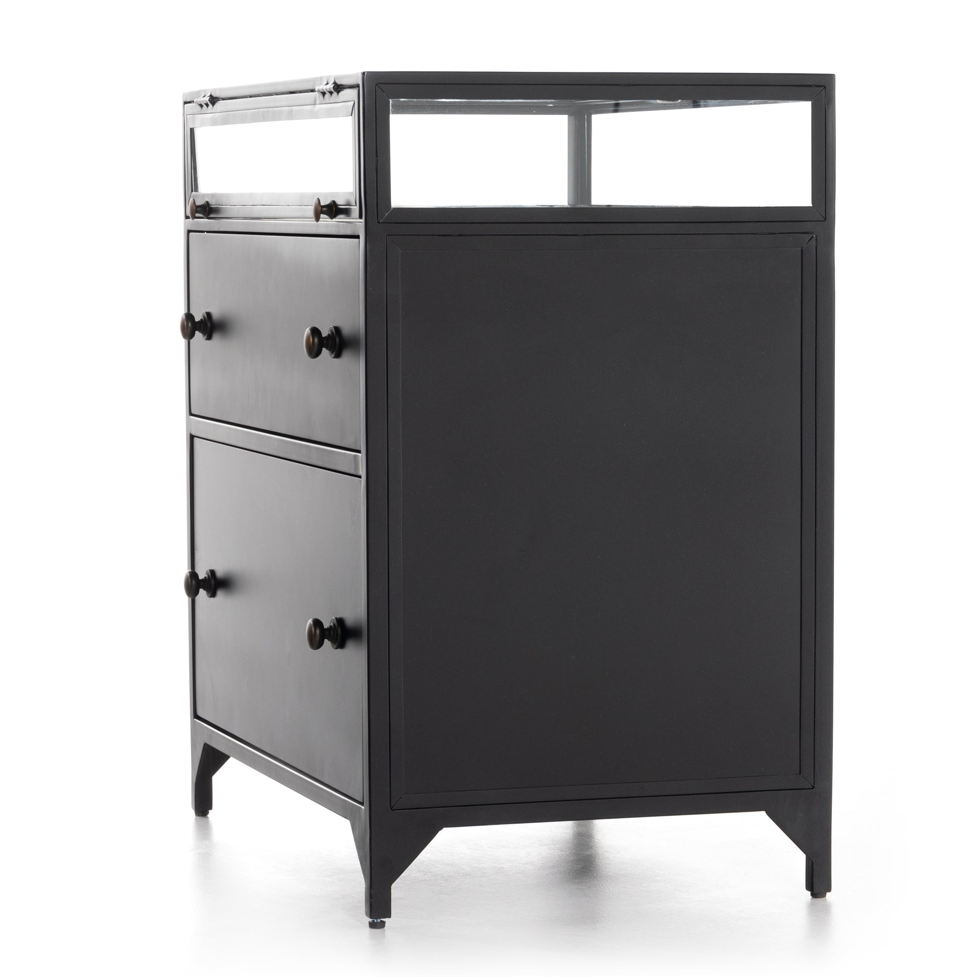This Shadow Box Nightstand is finished in a gorgeous matte black. We love that the glass top allows you to showcase your favorite jewelry or family keepsake, while the two spacious drawers give you storage space. The knobs are finished in bronze to give this piece a sleek contrast.  Overall Dimensions: 28.00"w x 17.75"d x 30.00"h Materials: Iron, Tempered Glass, Glass