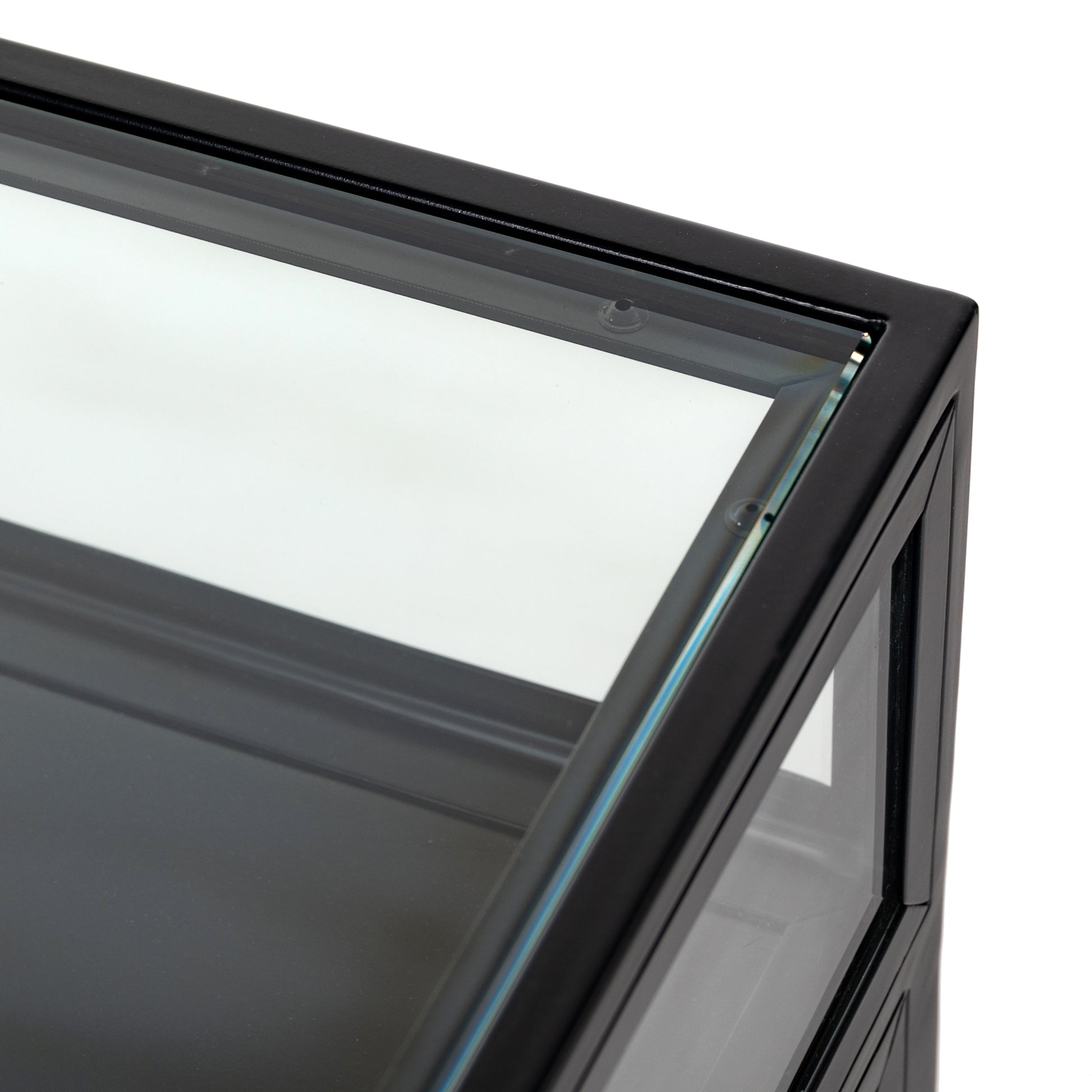 This Shadow Box Nightstand is finished in a gorgeous matte black. We love that the glass top allows you to showcase your favorite jewelry or family keepsake, while the two spacious drawers give you storage space. The knobs are finished in bronze to give this piece a sleek contrast.  Overall Dimensions: 28.00"w x 17.75"d x 30.00"h Materials: Iron, Tempered Glass, Glass