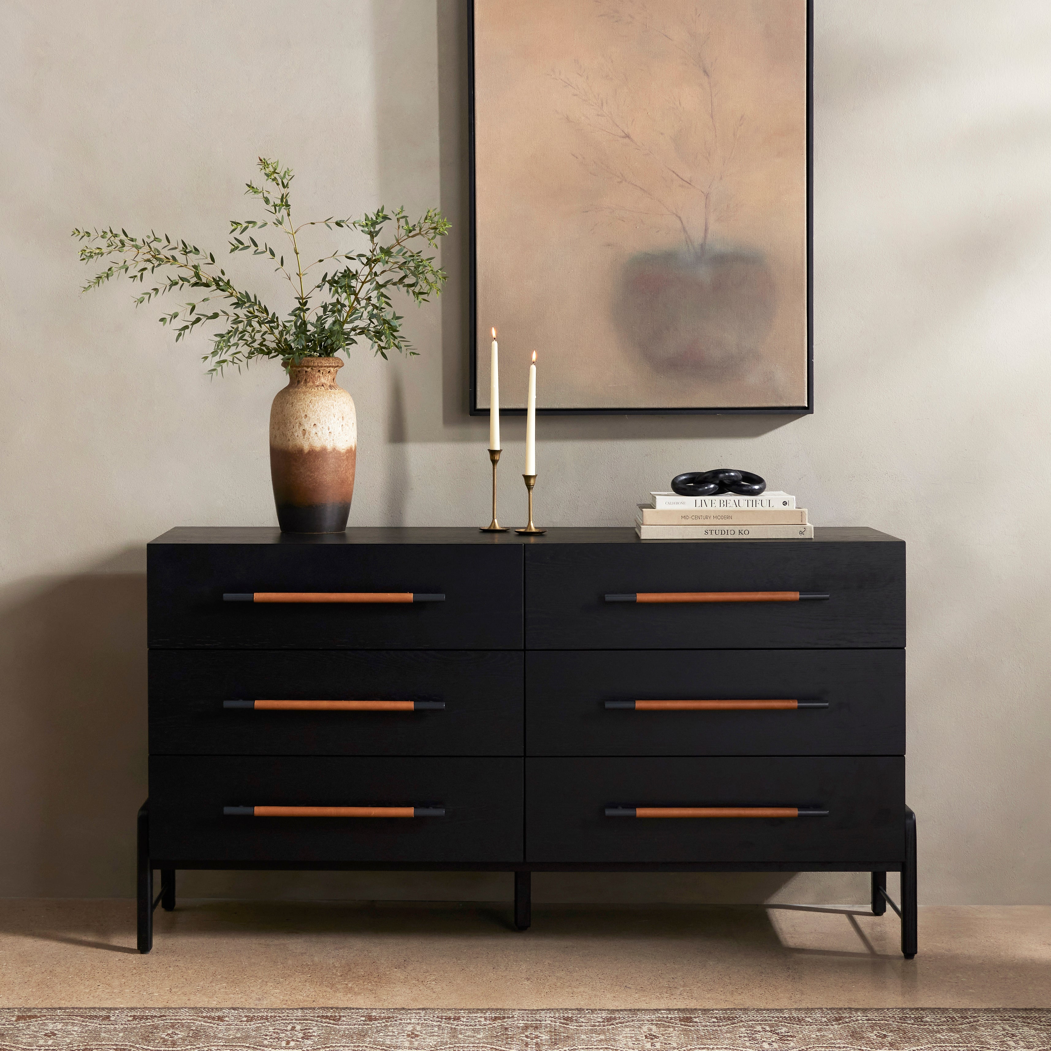 The ebony oak of this Rosedale 6 Drawer Dresser brings a moody, darkness to any room. With six spacious drawers and iron hardware wrapped in a gorgeous, tan leather, this is a functional and beautiful piece to add to your bedroom or other area.  Amethyst Home provides interior design, new home construction design consulting, vintage area rugs, and lighting in the San Diego metro area.