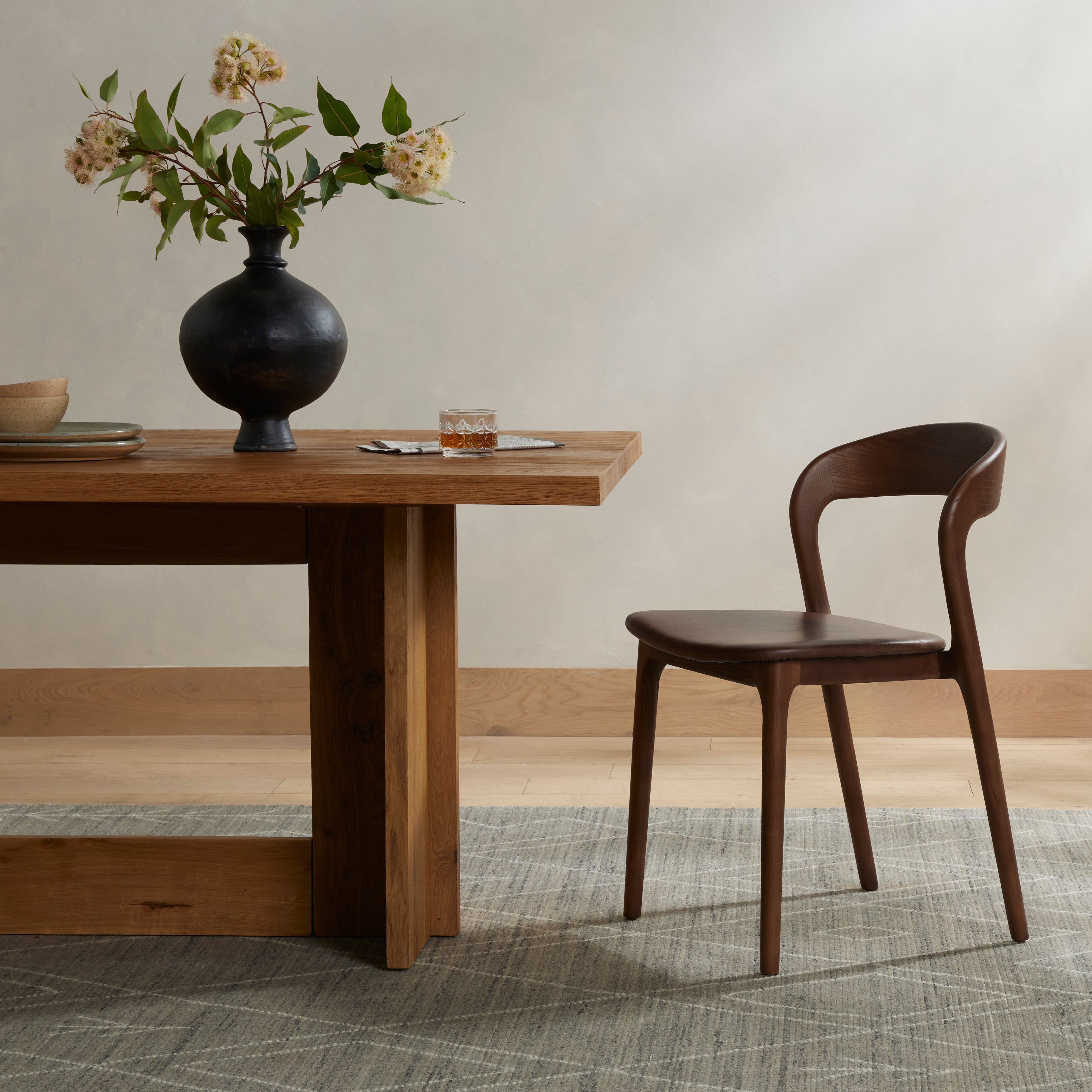 Inspired by clean, simple Scandinavian styling, solid ash forms a shapely, open frame for tan top-grain leather seating in a monochromatic tone. Amethyst Home provides interior design, new construction, custom furniture, and area rugs in the Charlotte metro area.